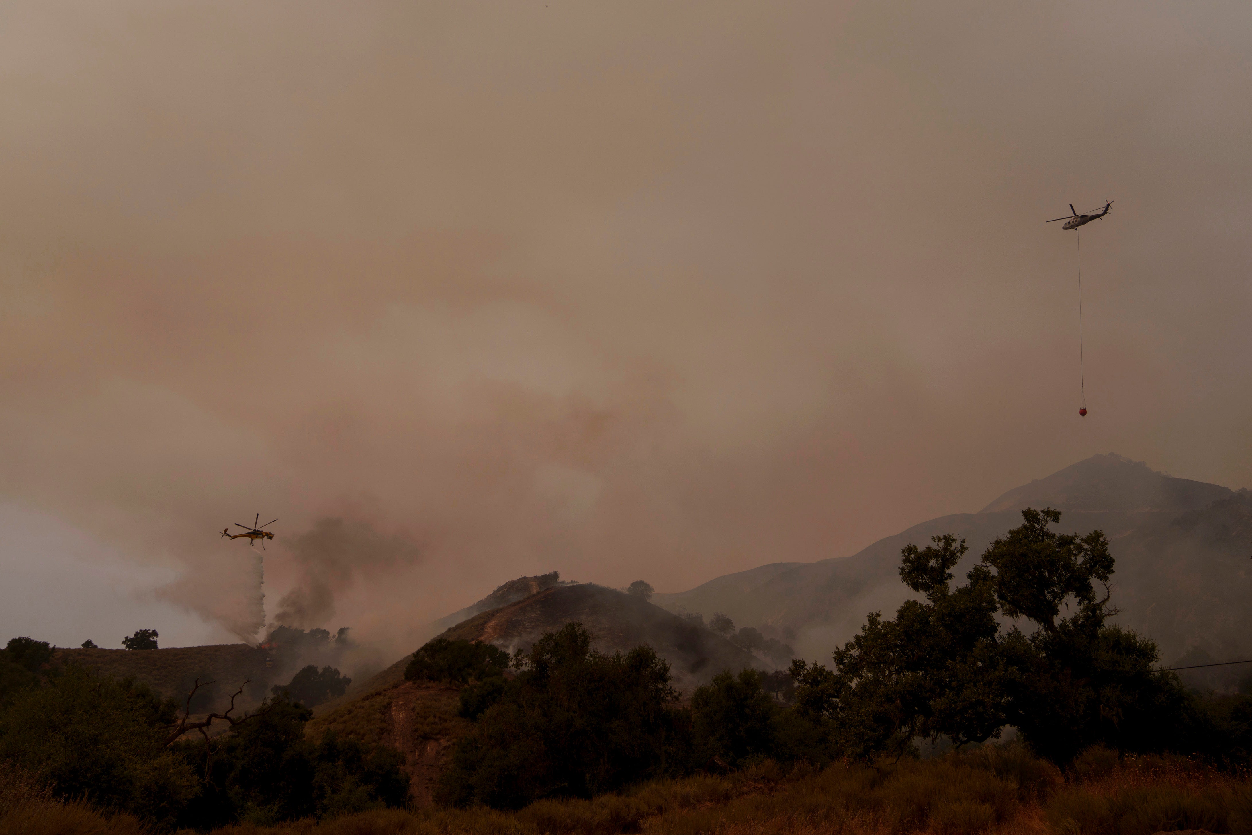 Helicopters drop water onto Lake Fire, devastating Santa Barbara County. Officials say just 8 percent of the fire is contained