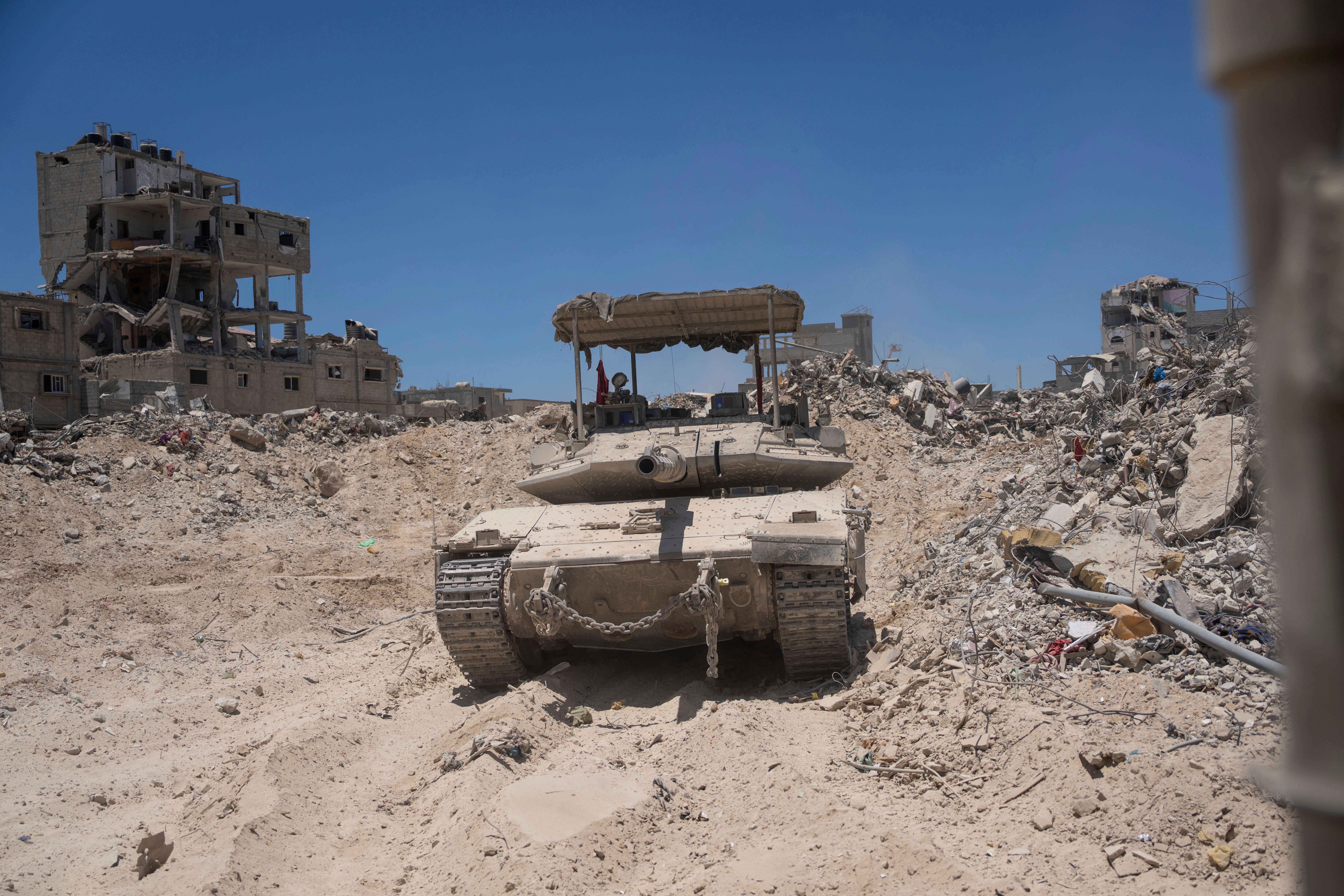 An Israeli tank is seen next to destroyed buildings in the southern Gaza Strip, Wednesday, July 3, 2024
