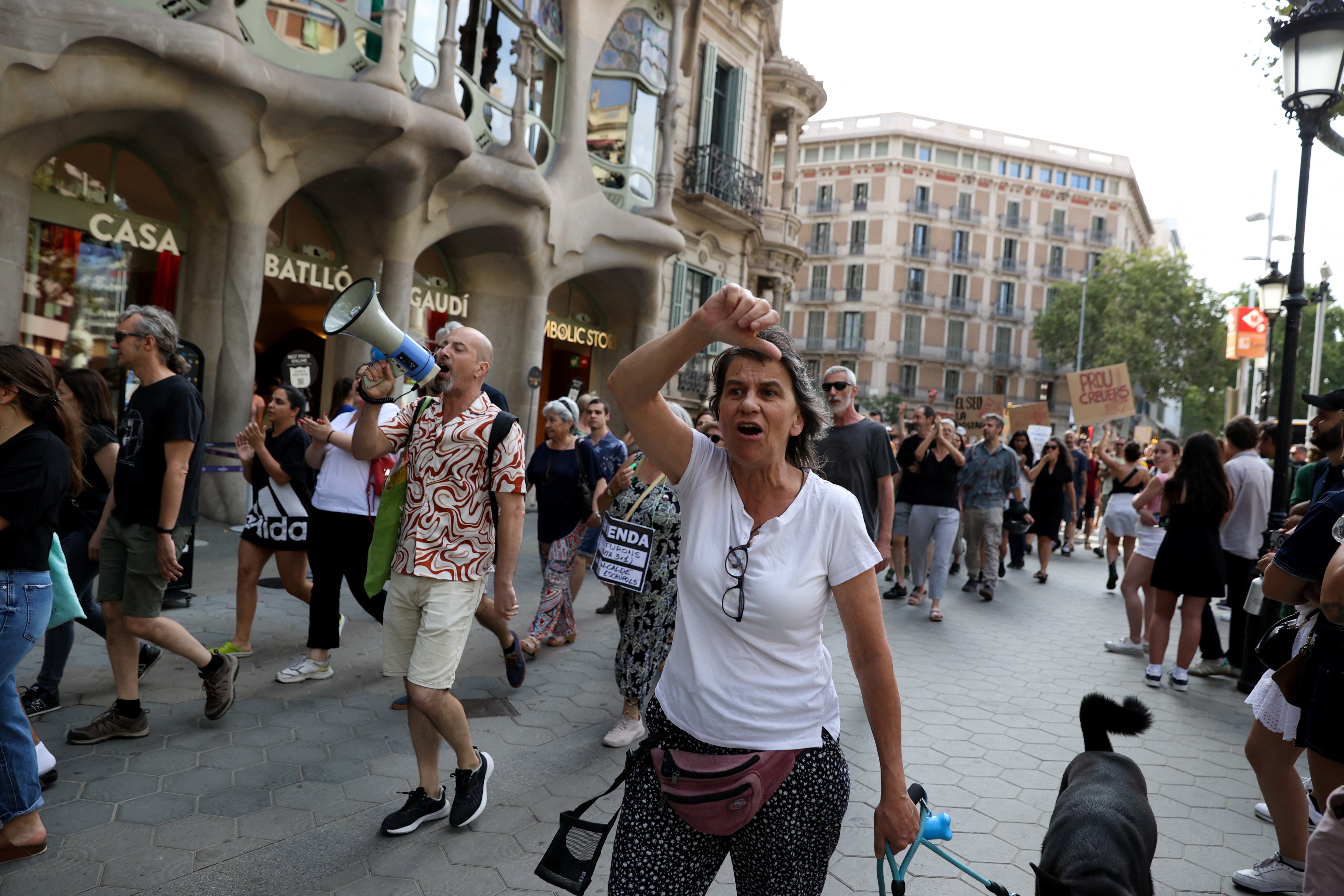 A woman shouts at tourists to go home during a protest against mass tourism in Barcelona