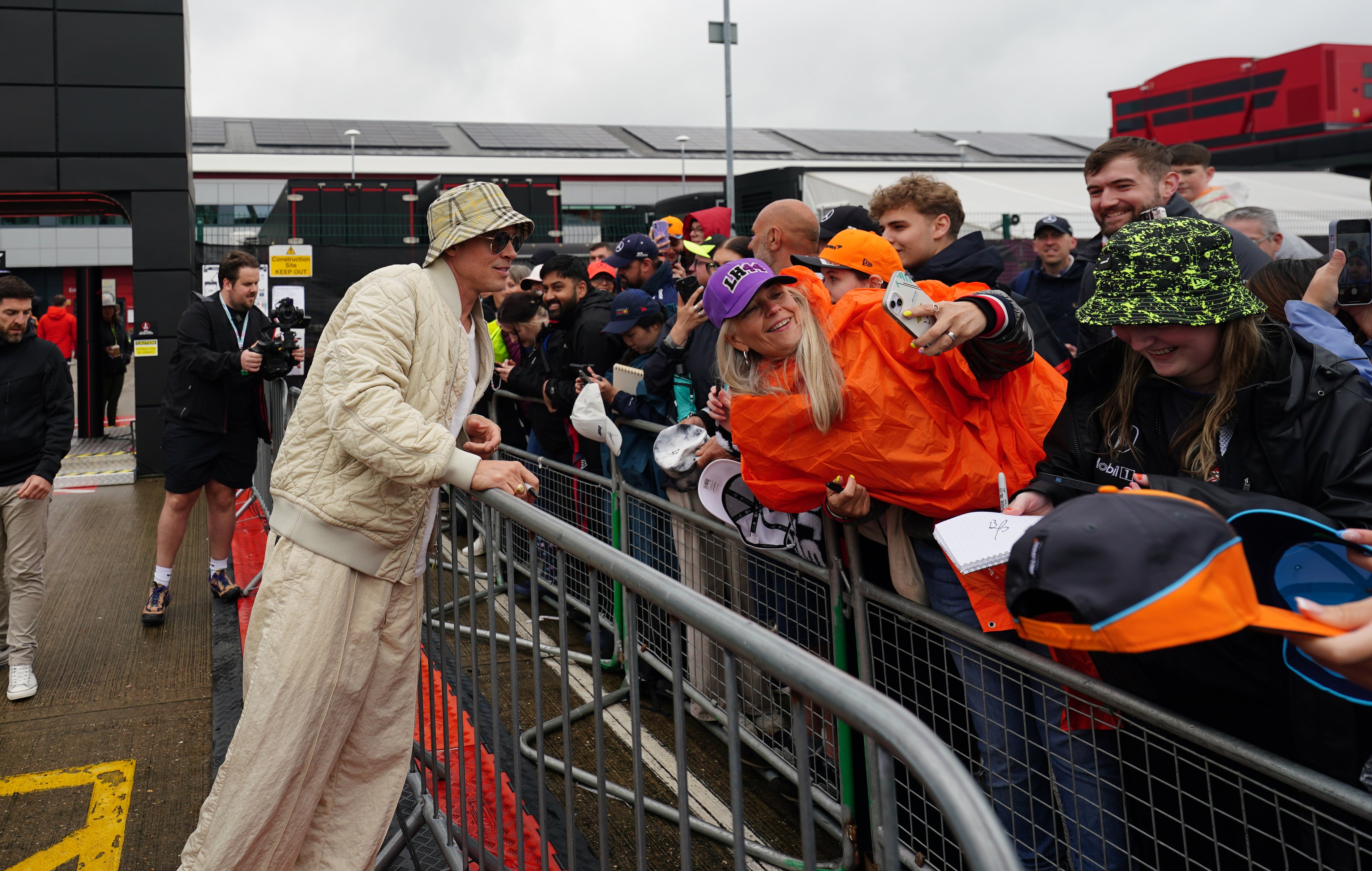 The star’s was dressed in head-to-toe beige with matching beige slacks as he smiled for fan photographs (David Davies/PA)