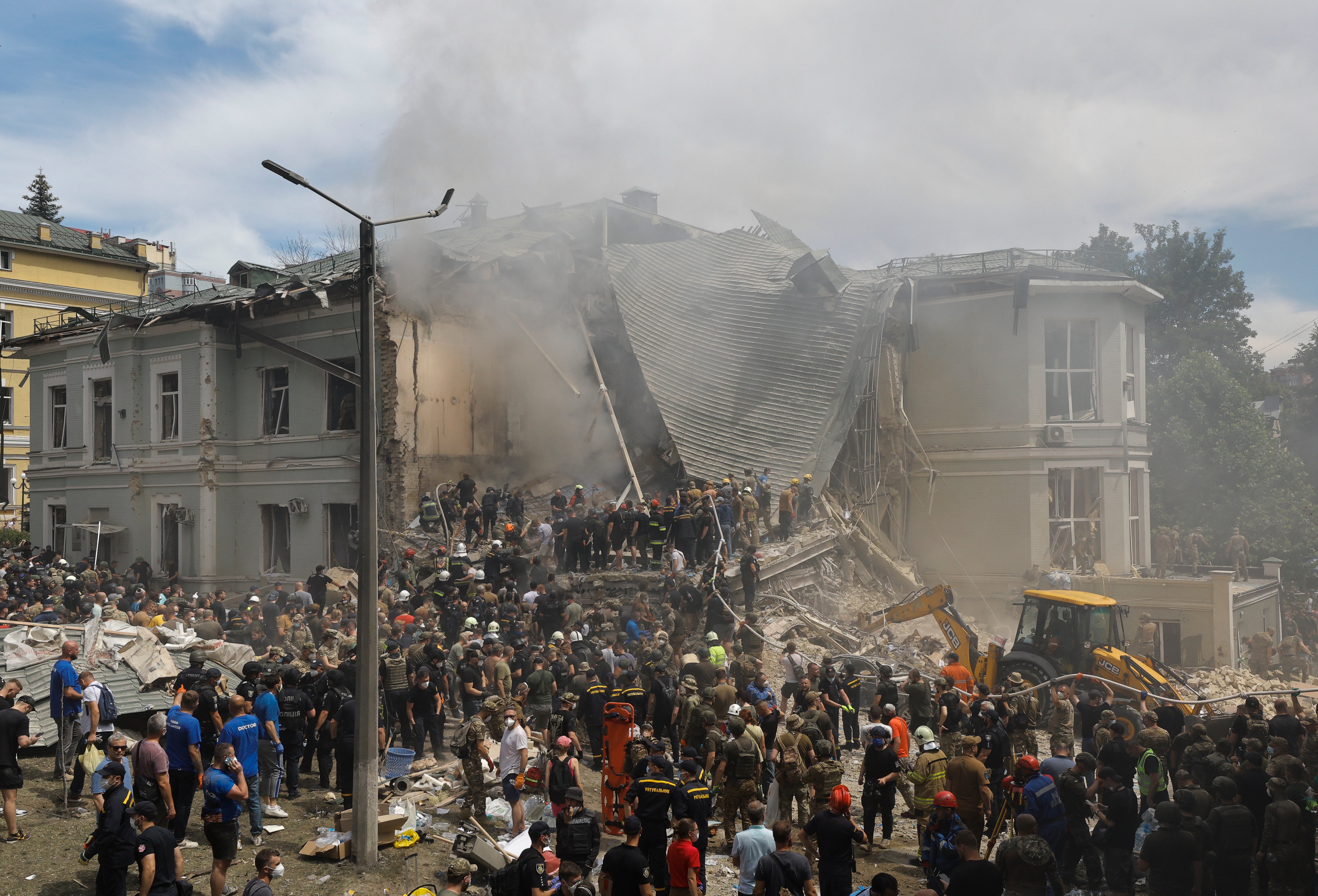 Rescue workers at the site of a rocket strike on the 'Okhmadyt' children's hospital in Kyiv