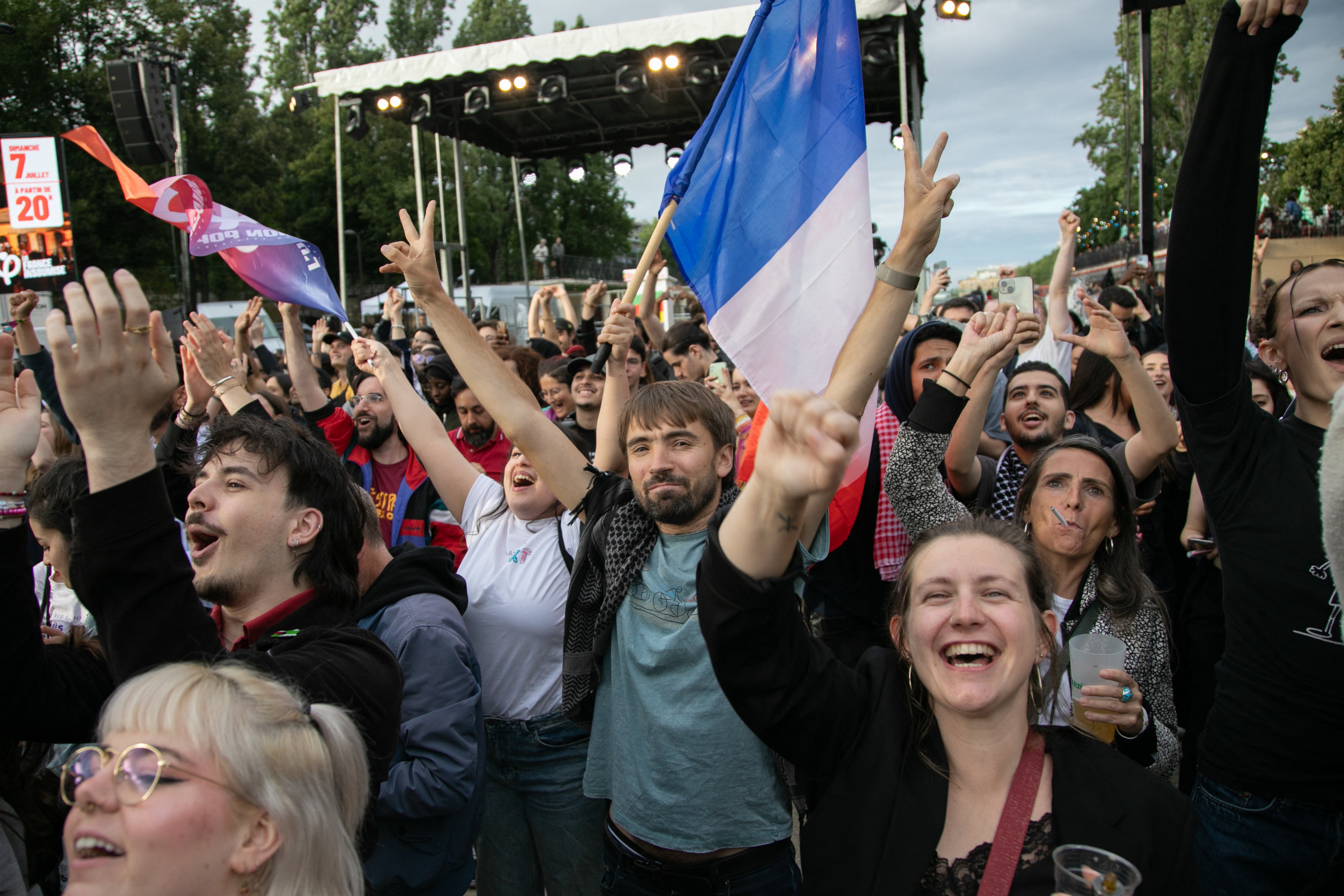 A crowd in Paris reacts to the results of the second round of the election