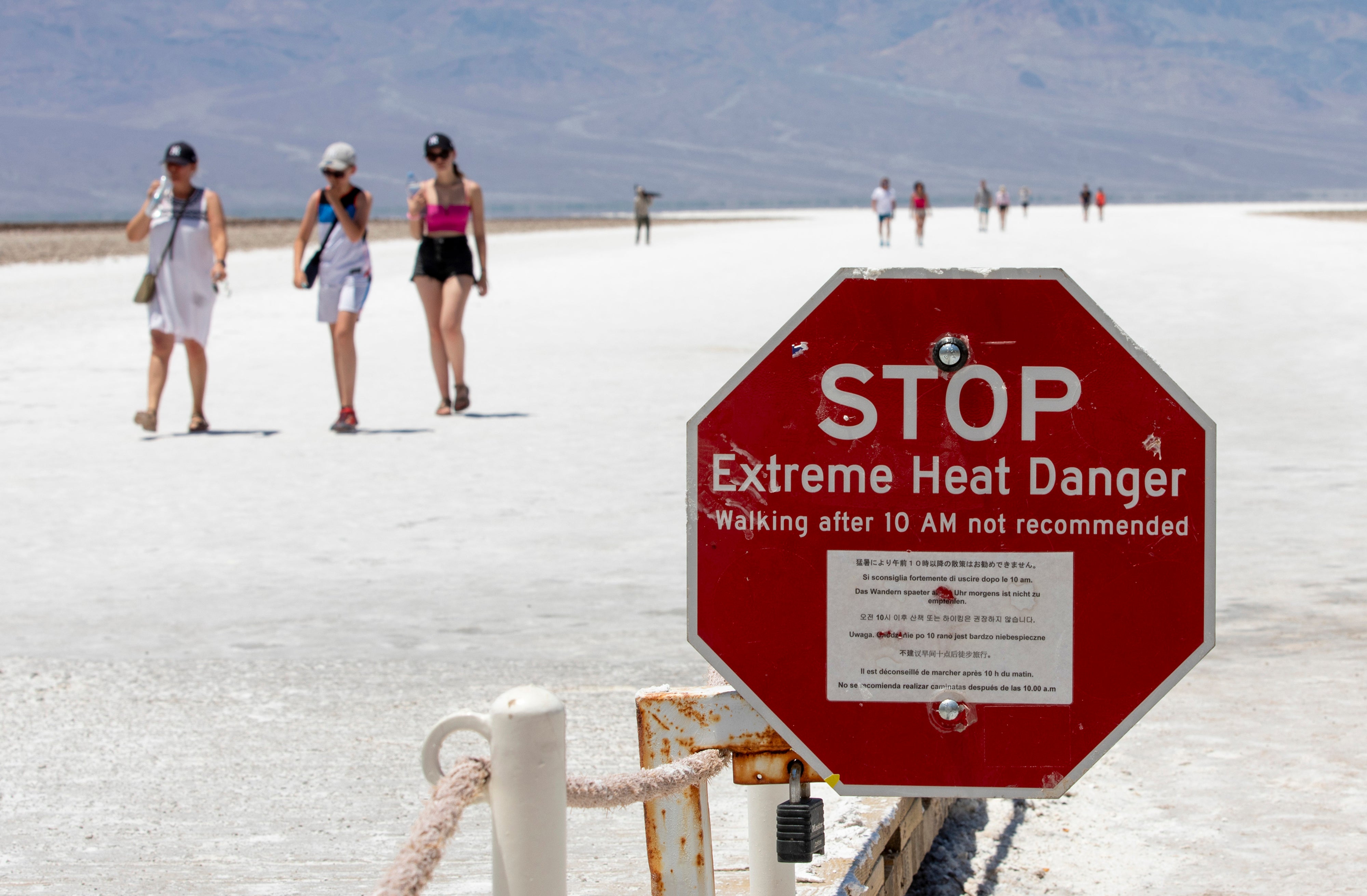 A stop sign warns tourists of extreme heat at Badwater Basin on July 8 in Death Valley National Park. A Belgian tourist suffered third-degree burns on his foot when his skin was exposed to extremely hot sand on one of the park’s dunes in July 2024