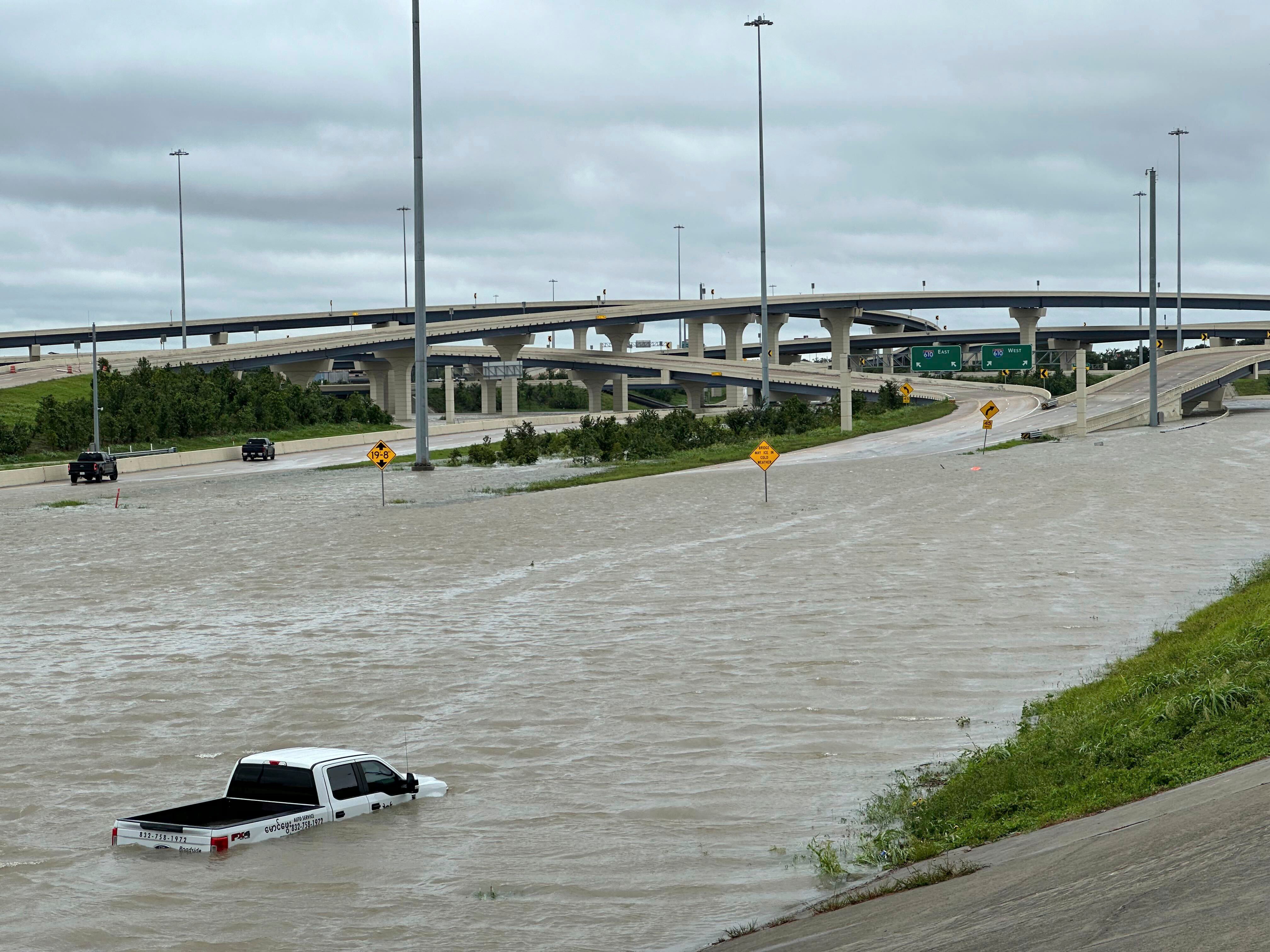 A vehicle is stranded in high waters on a flooded highway in Houston, on Monday, July 8, 2024 after Hurricane Beryl ripped through the area