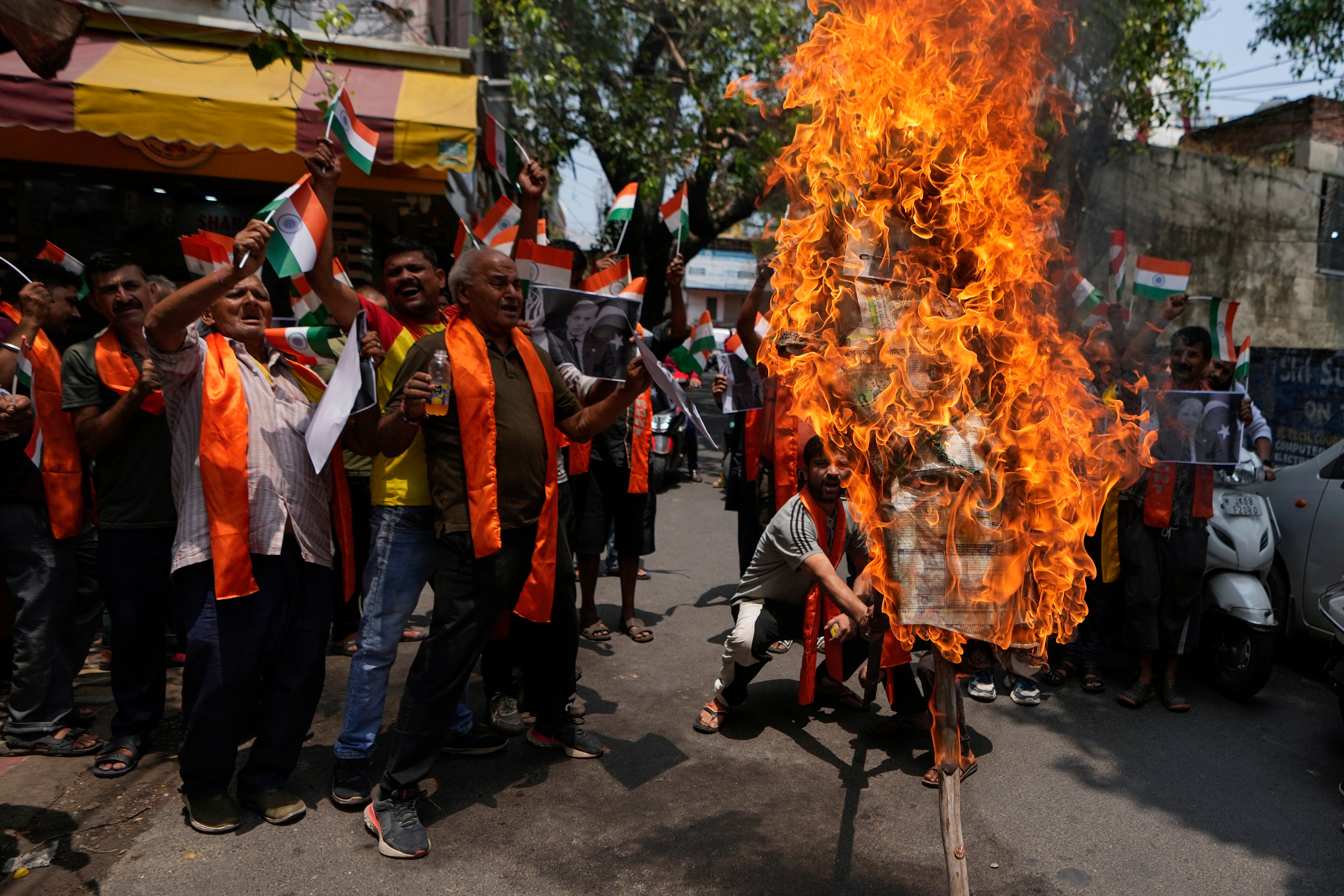 Activists from right-wing Hindu groups react to Monday’s killing of five Indian soldiers in Kashmir by burning an effigy of the Pakistan PM