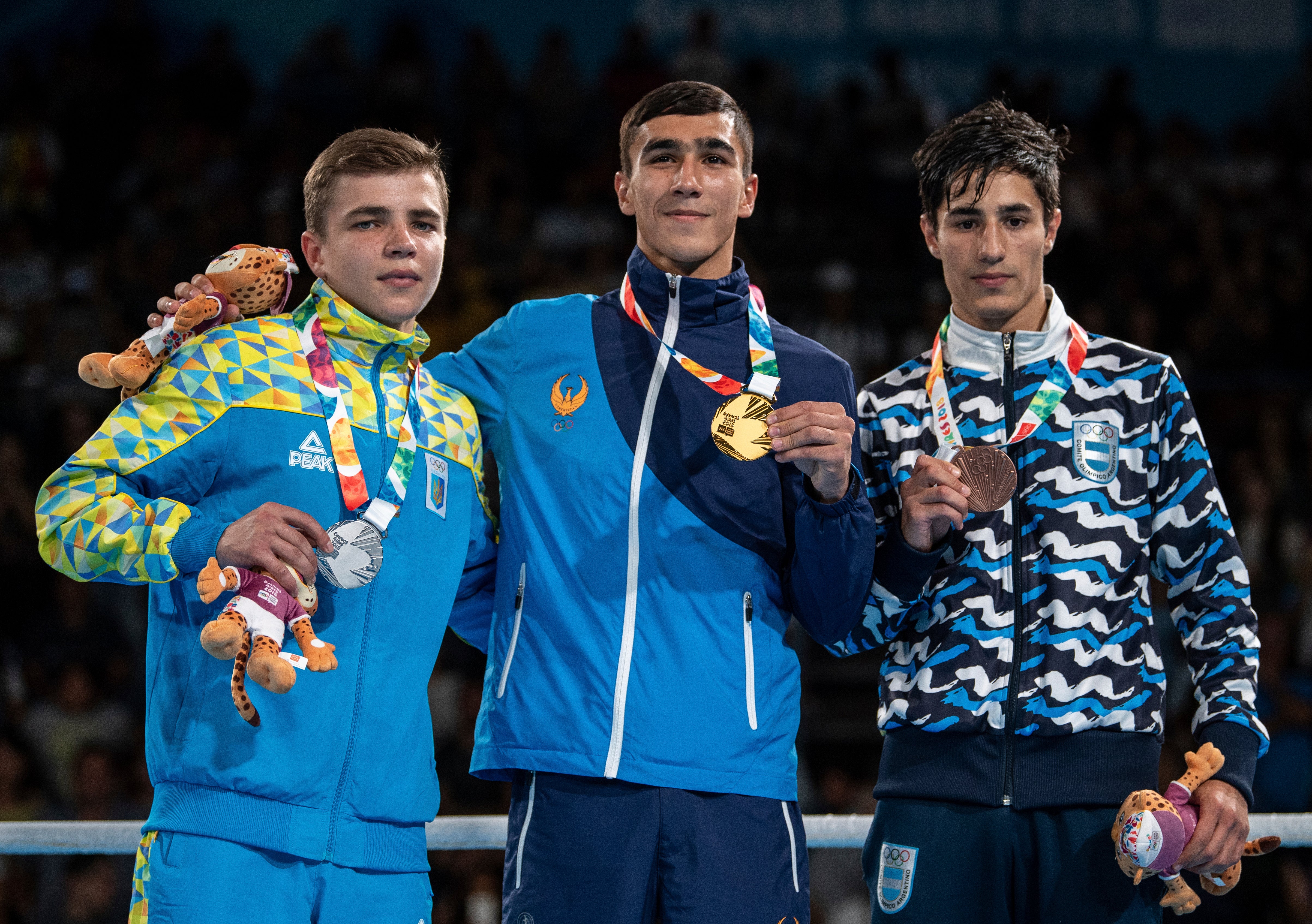 From left, silver medalist Maksym Halinichev of Ukraine, gold medalist Abdumalik Khalokov of Uzbekistan and bronze medalist Mirco Jehiel Cuello of Argentina stand together during the medal ceremony for the Boxing Mens Bantam (up to 56kg) during The Youth Olympic Games in Buenos Aires