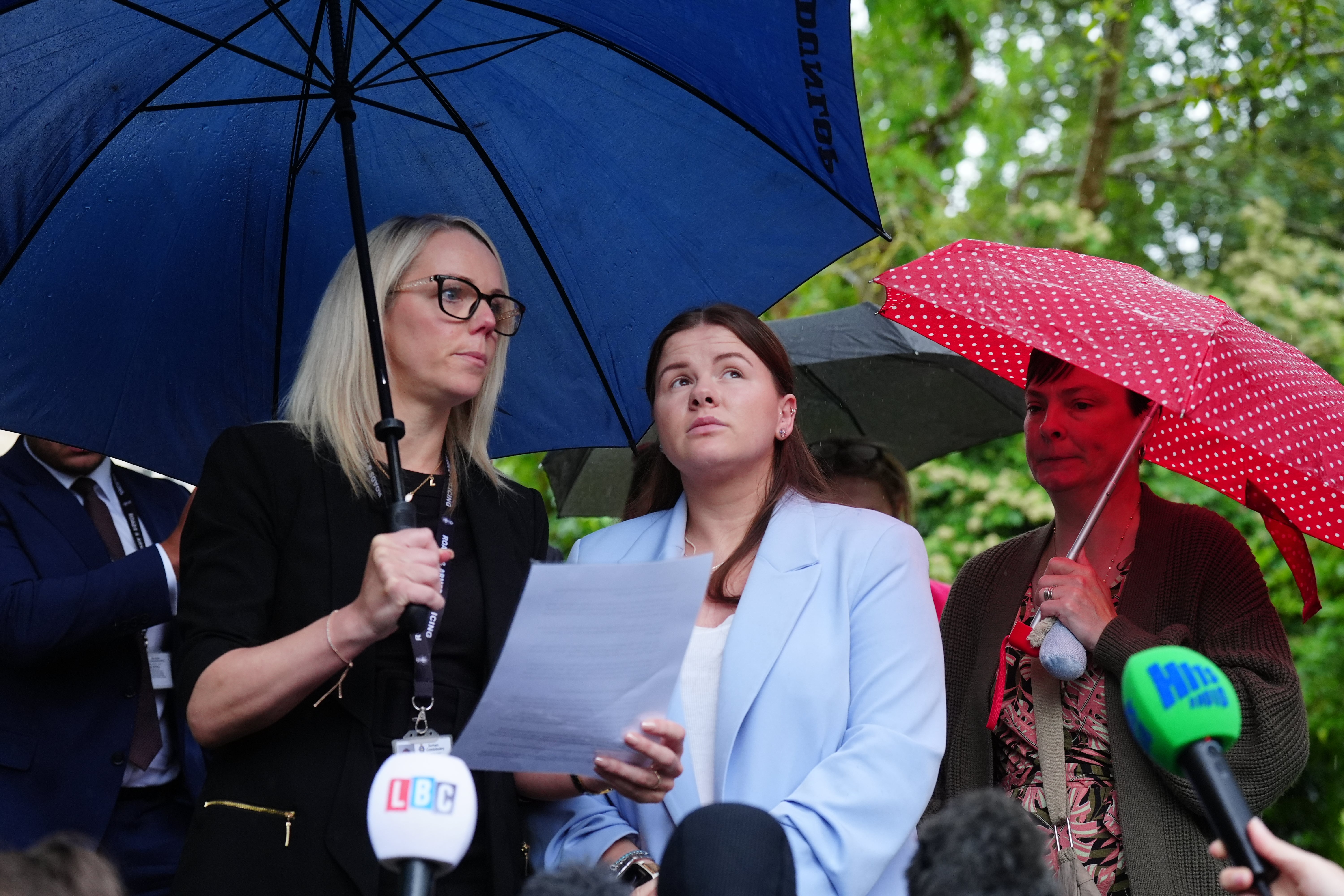 Detective Constable Natalie Horner (left) reads a statement to the media beside Sharlona Warner