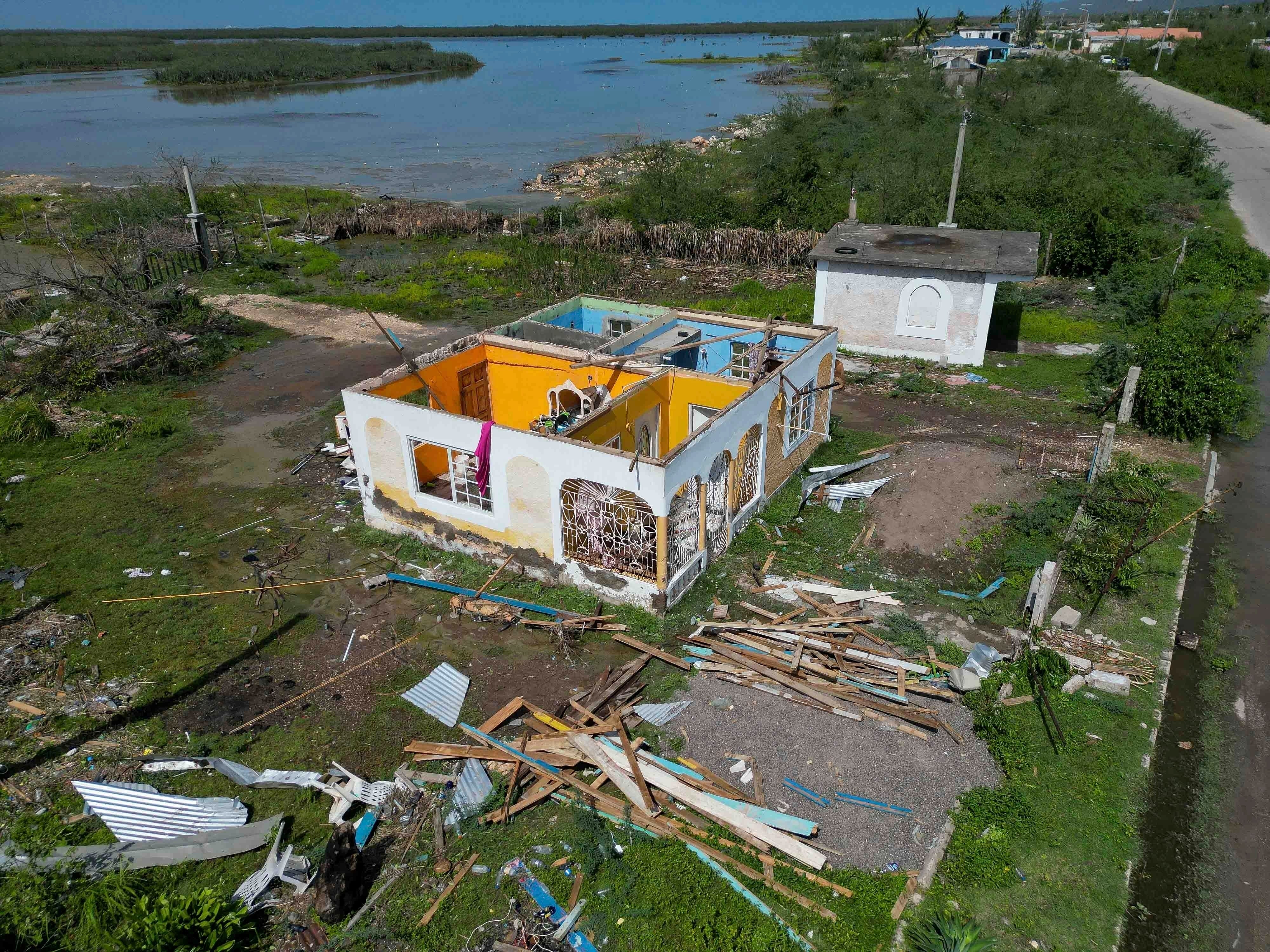 A house sits roofless after being damaged by Hurricane Beryl in Portland Cottage, Clarendon, Jamaica