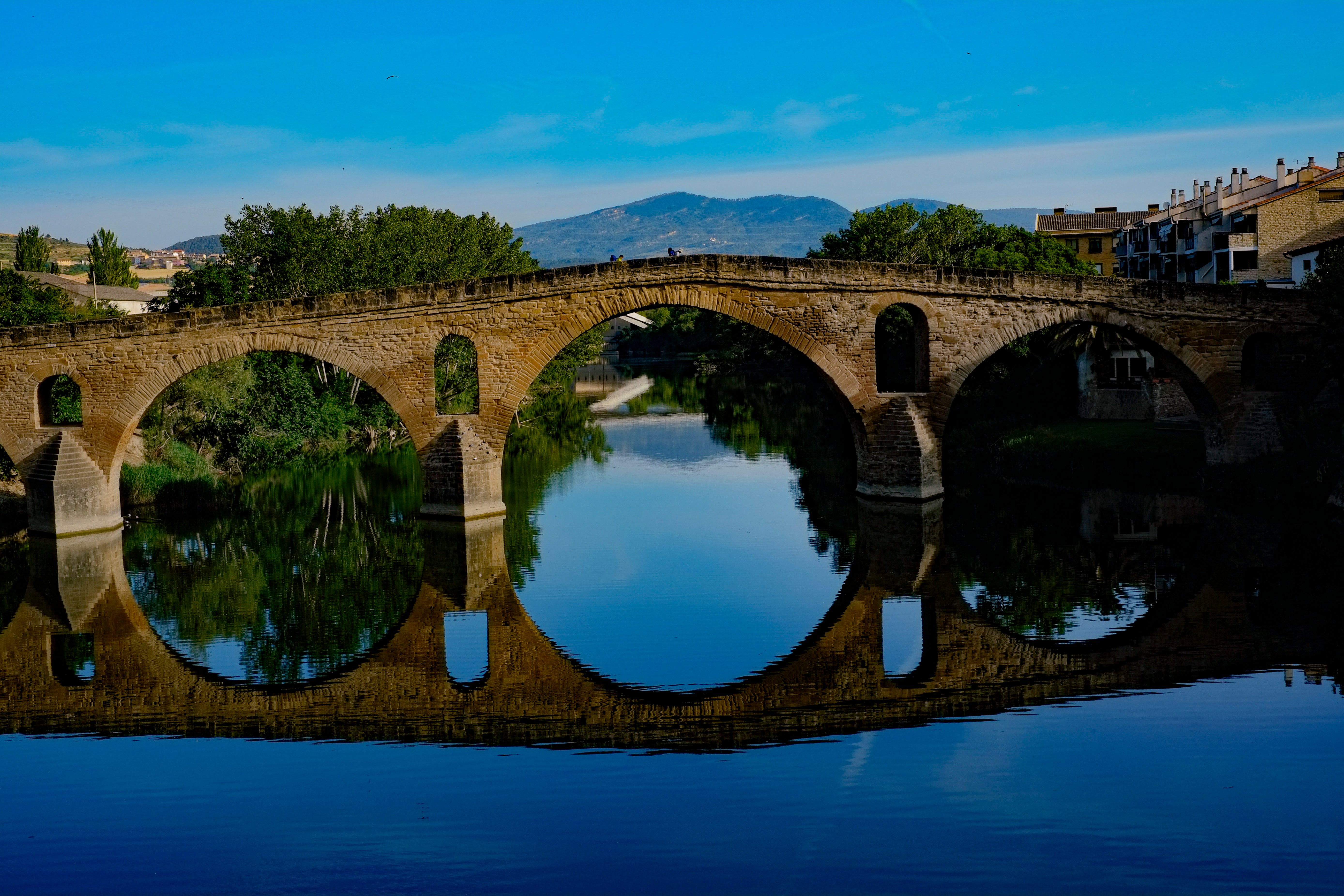 Pilgrims cross a bridge during a stage of the Camino de Santiago