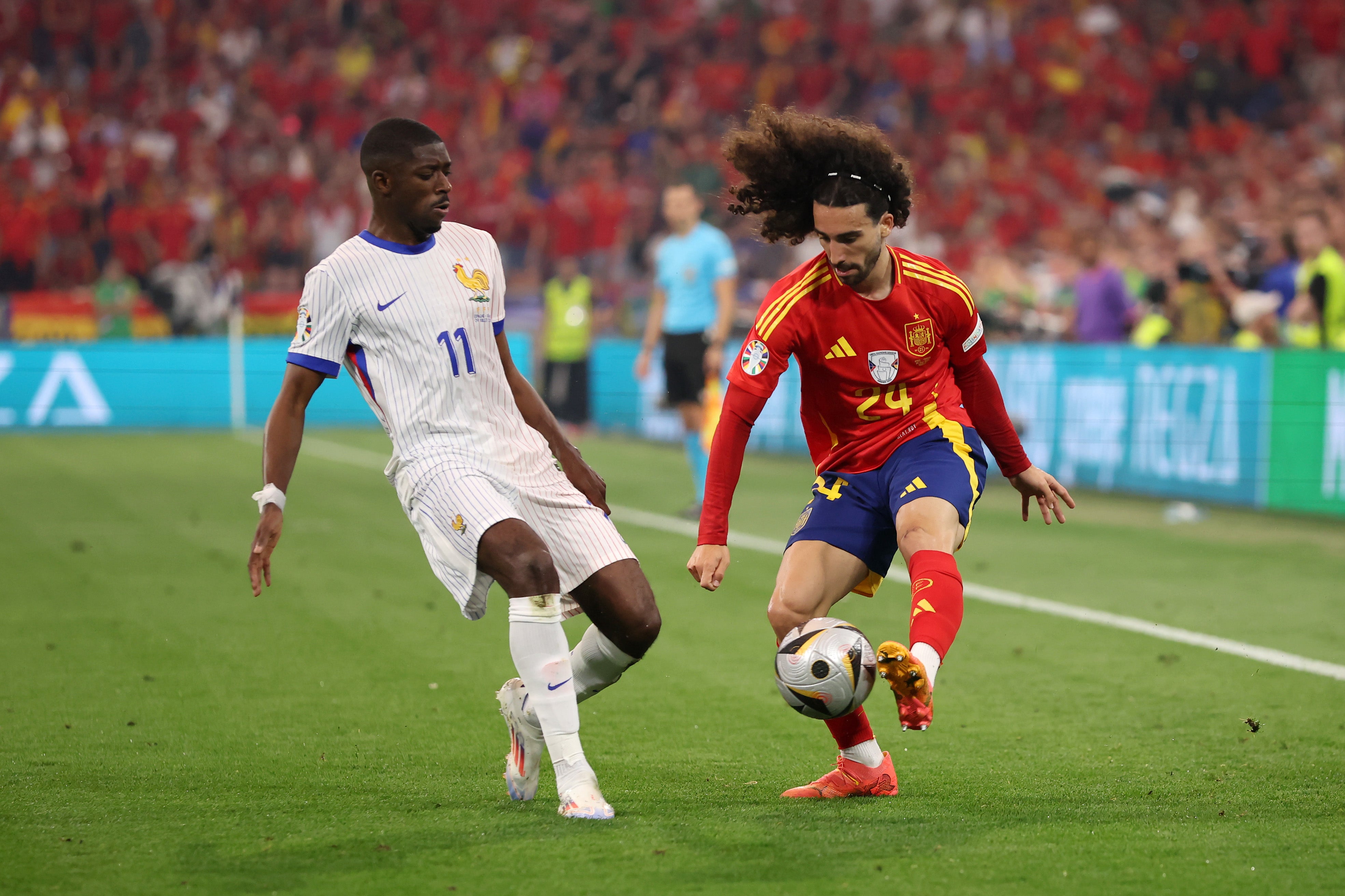 Marc Cucurella (right) looking to get past Ousmane Dembele