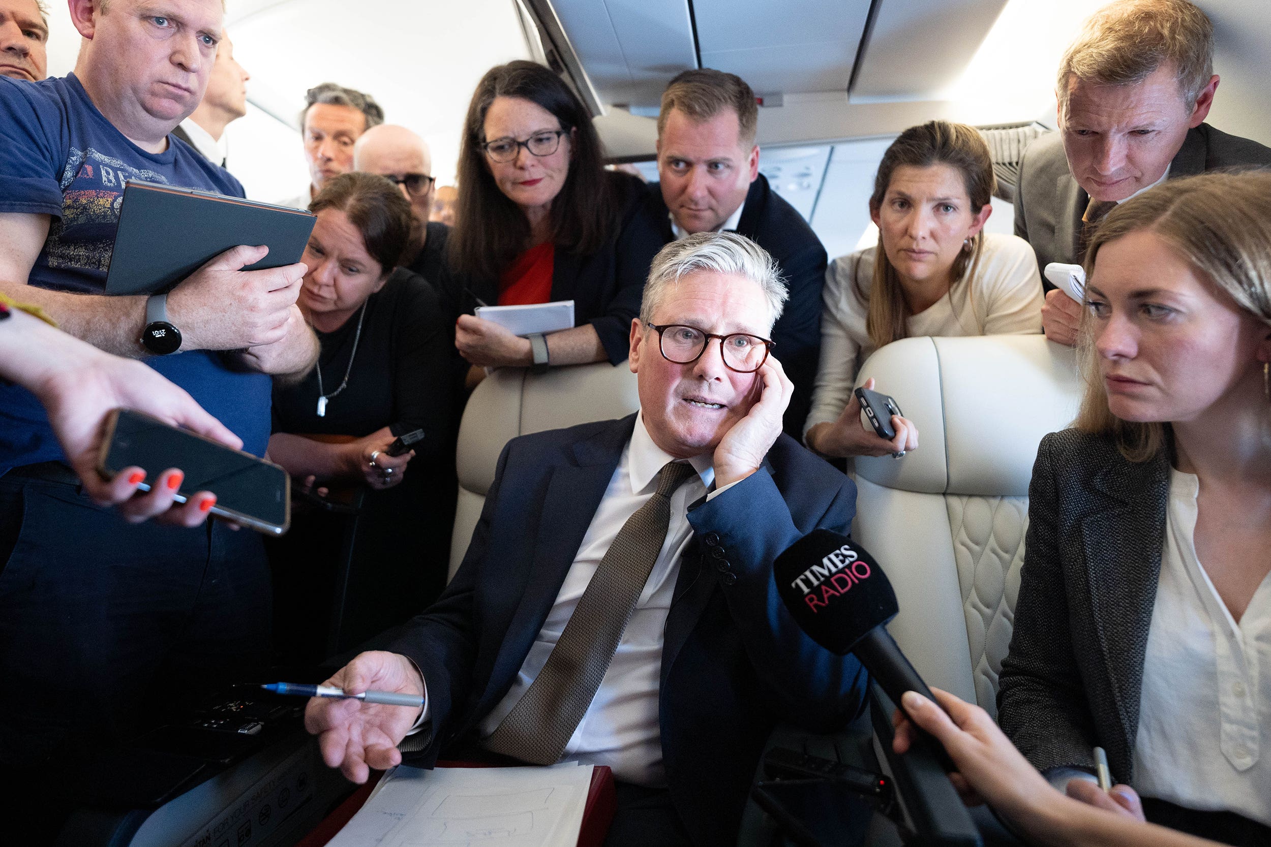 Prime Minister Sir Keir Starmer talks to journalists as he travels onboard a plane to Washington DC (Stefan Rousseau/PA)