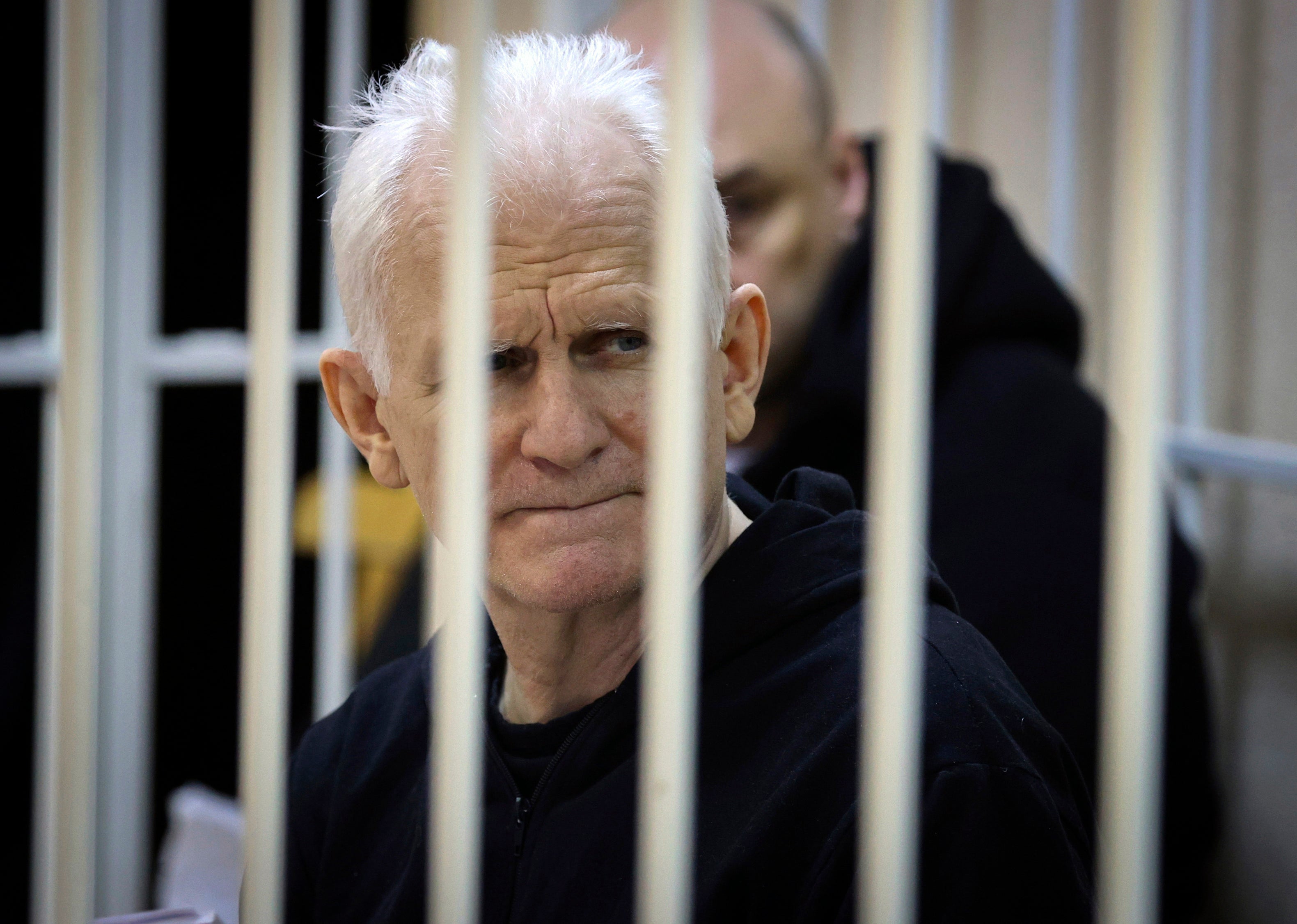 Ales Bialiatski, the head of Belarusian Vyasna rights group, sits in a defendant's cage during a court session in Minsk, Belarus, on 5 January 2023