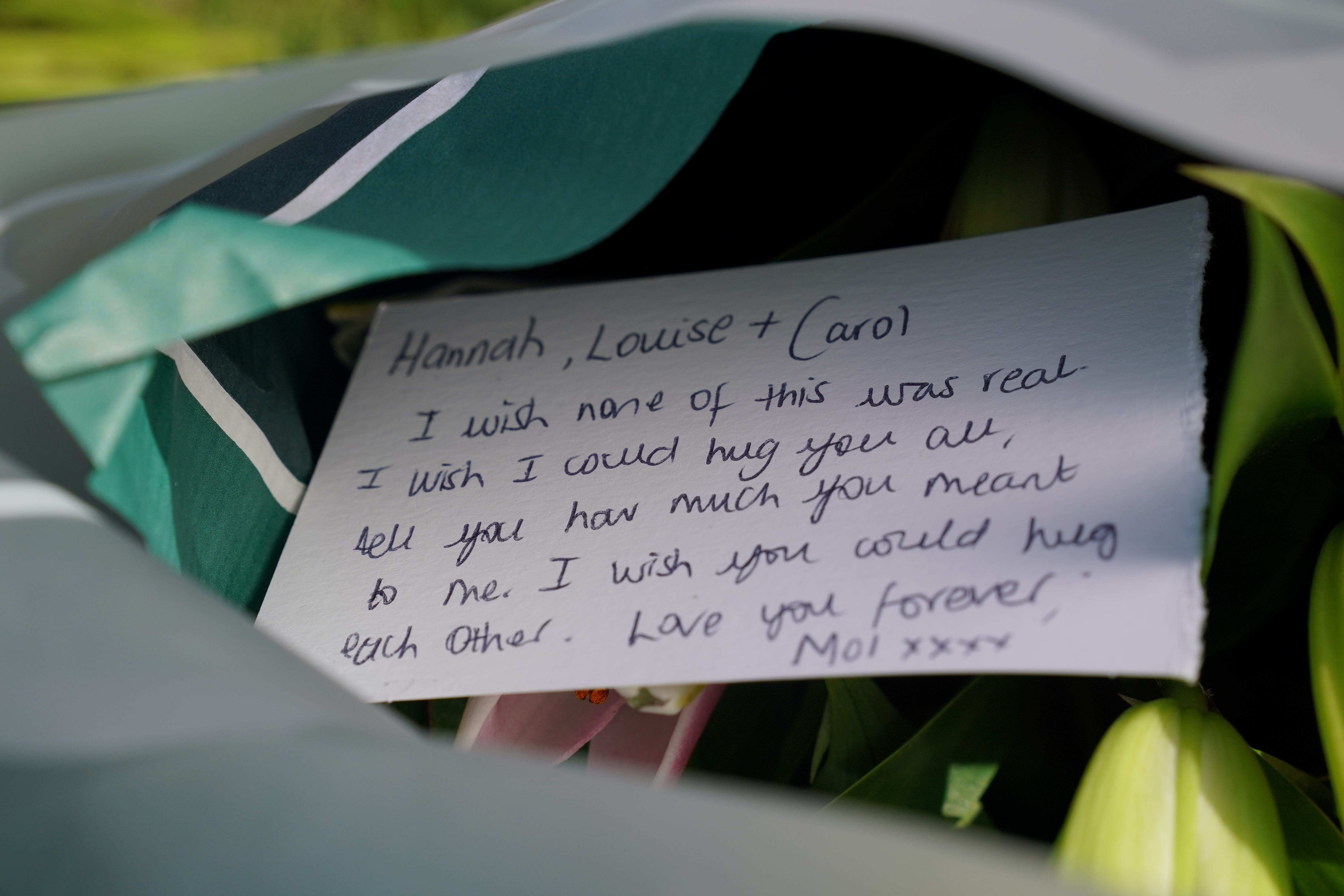 A message on a floral tribute near to the scene in Ashlyn Close (Jonathan Brady/PA)