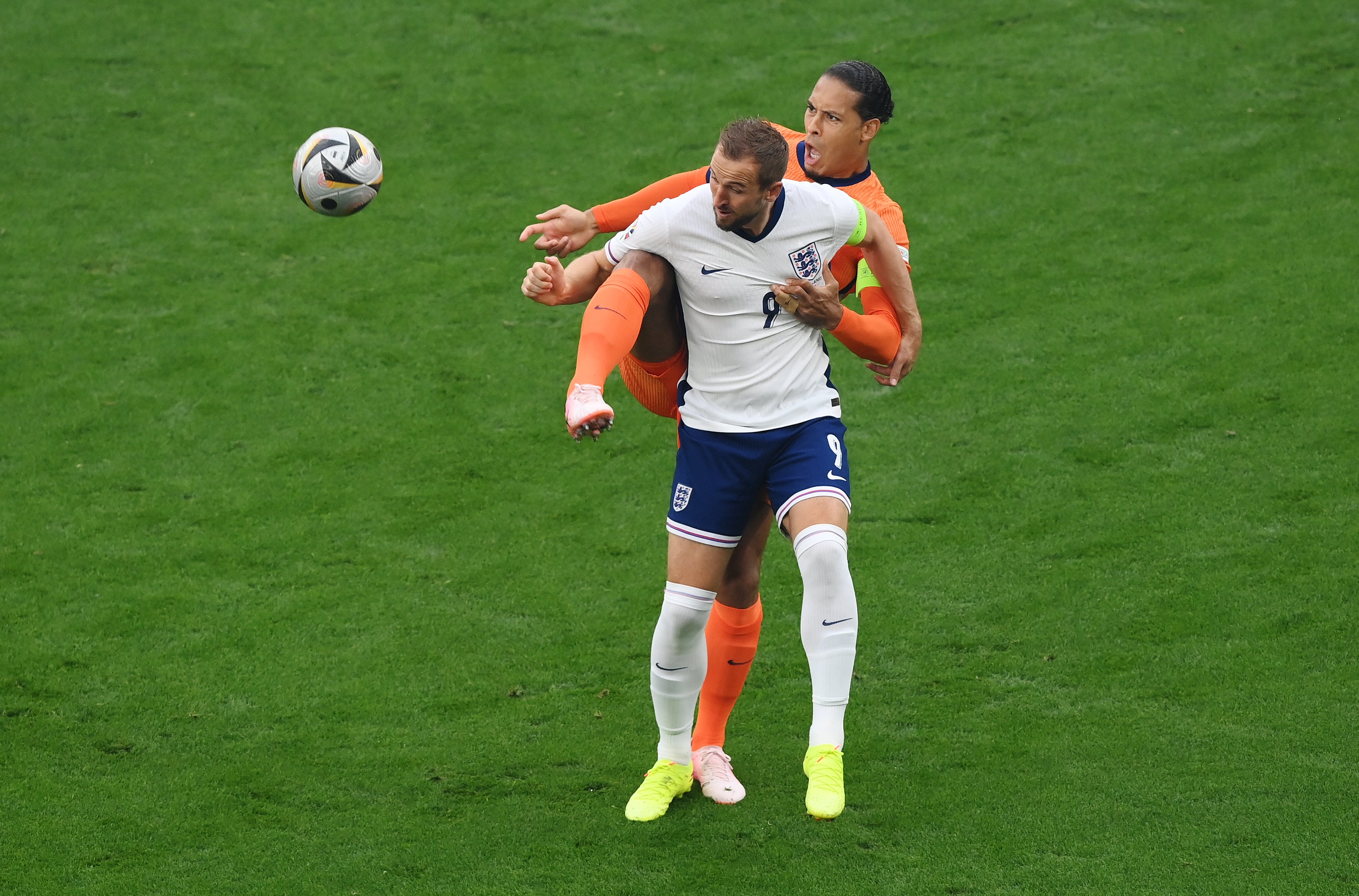 Netherlands captain Virgil van Dijk (right) in a duel with Harry Kane