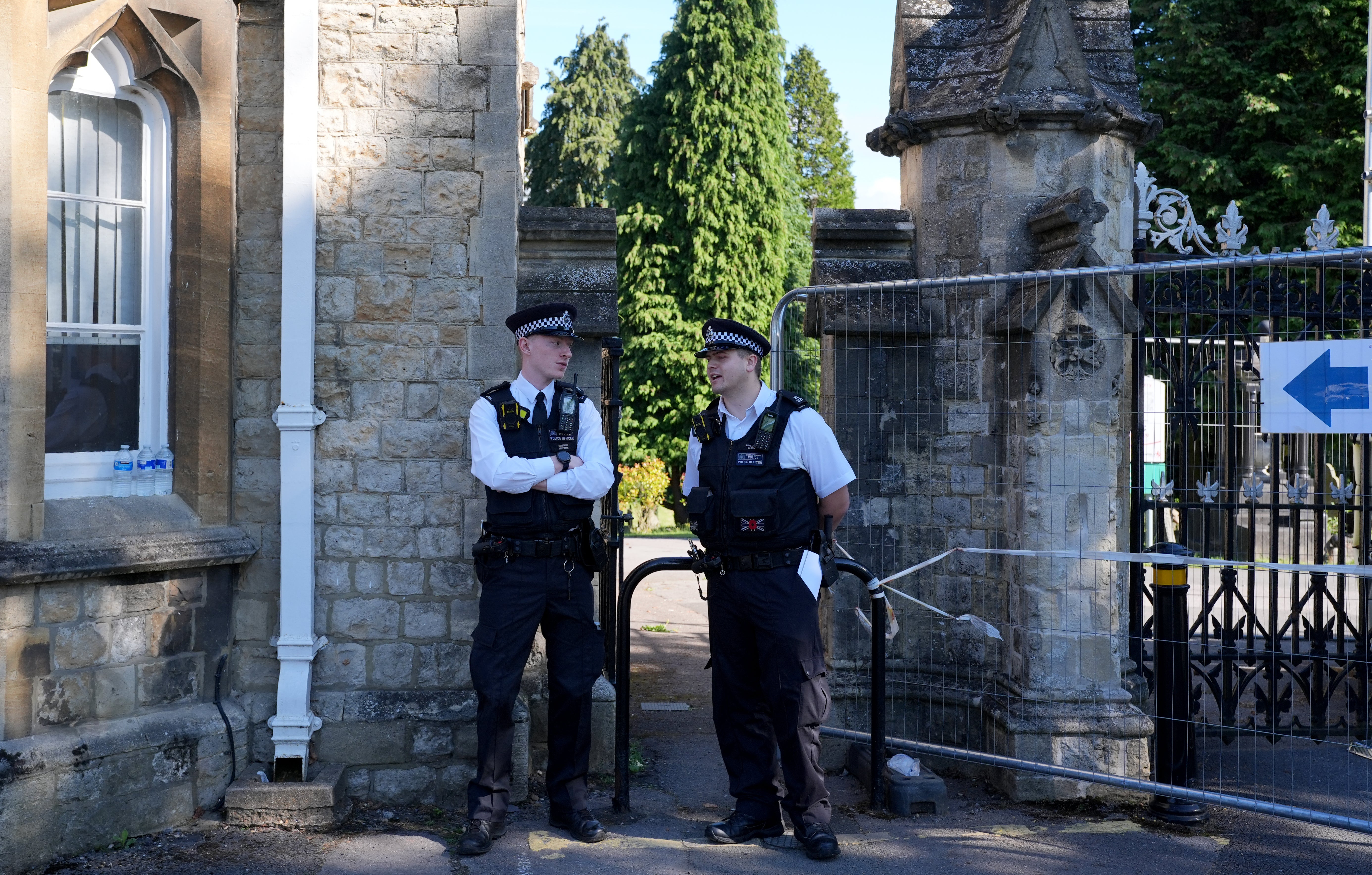 Police officers outside Lavender Hill Cemetery in Enfield, north London, where triple murder suspect Kyle Clifford, 26, was found