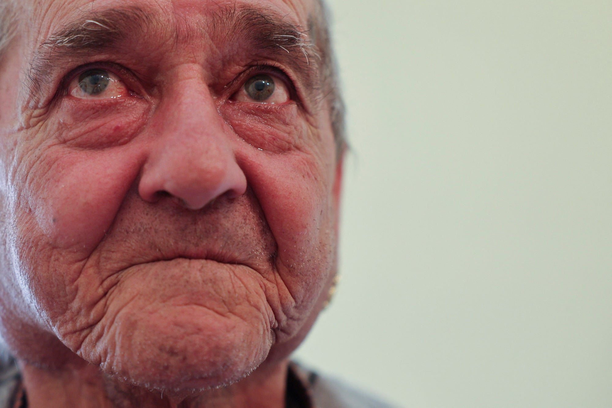 62-year-old pensioner Francisco Carrillo reacts after lying in the bed of his new apartment