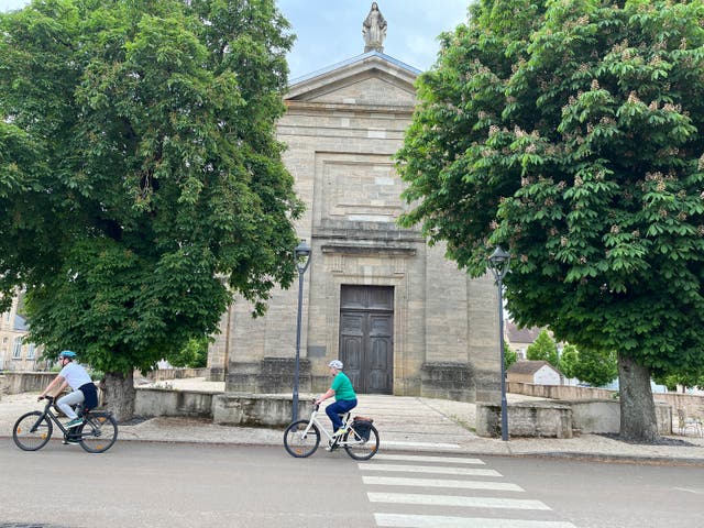 <p>Cyclists ride through the village of Pommard in the Burgundy region of France</p>