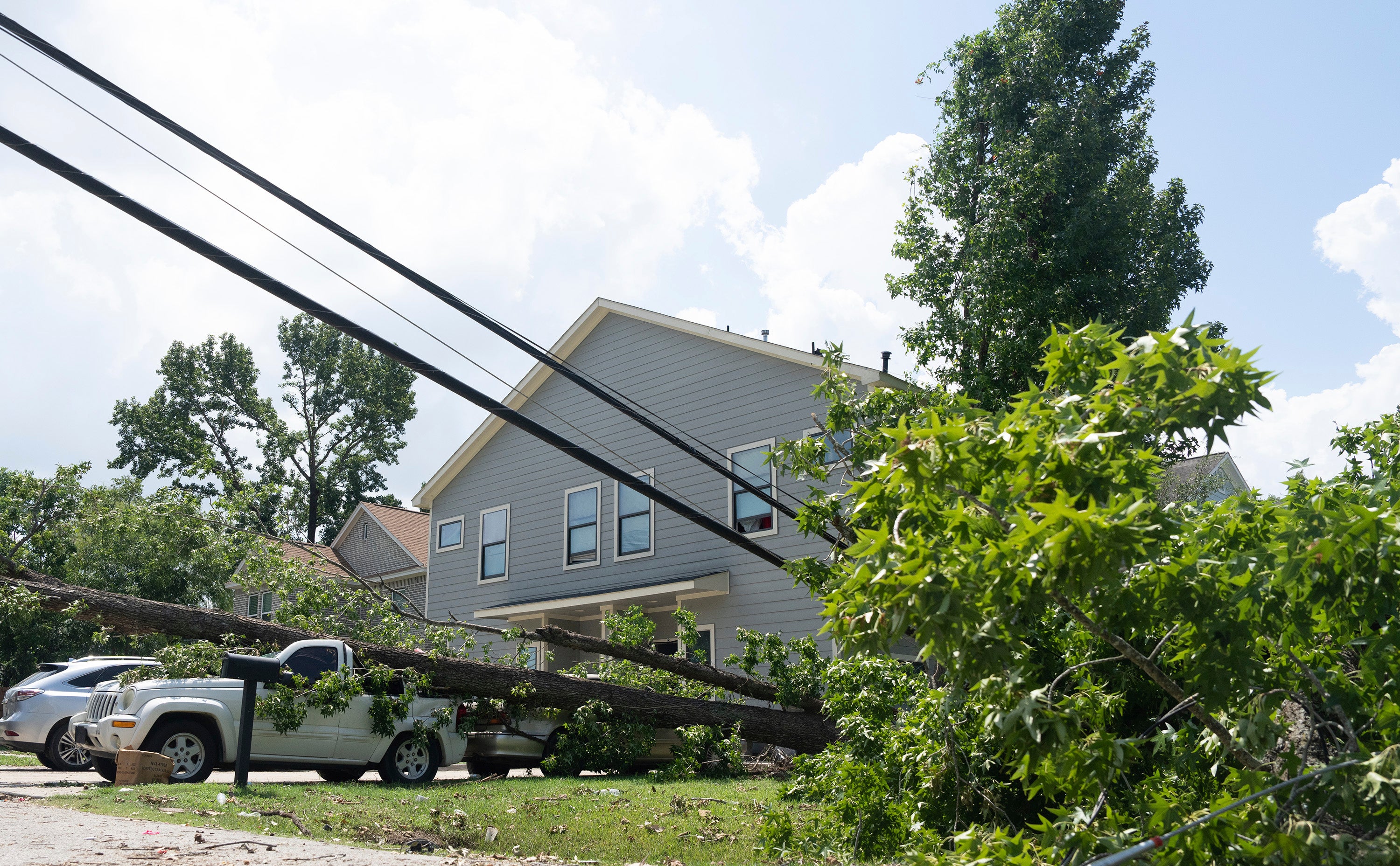 Hurricane Beryl knocked down power lines in Houston’s Acres Homes neighborhood in July. The storm hit during scorching summer heat, leading to power outages for millions of residents