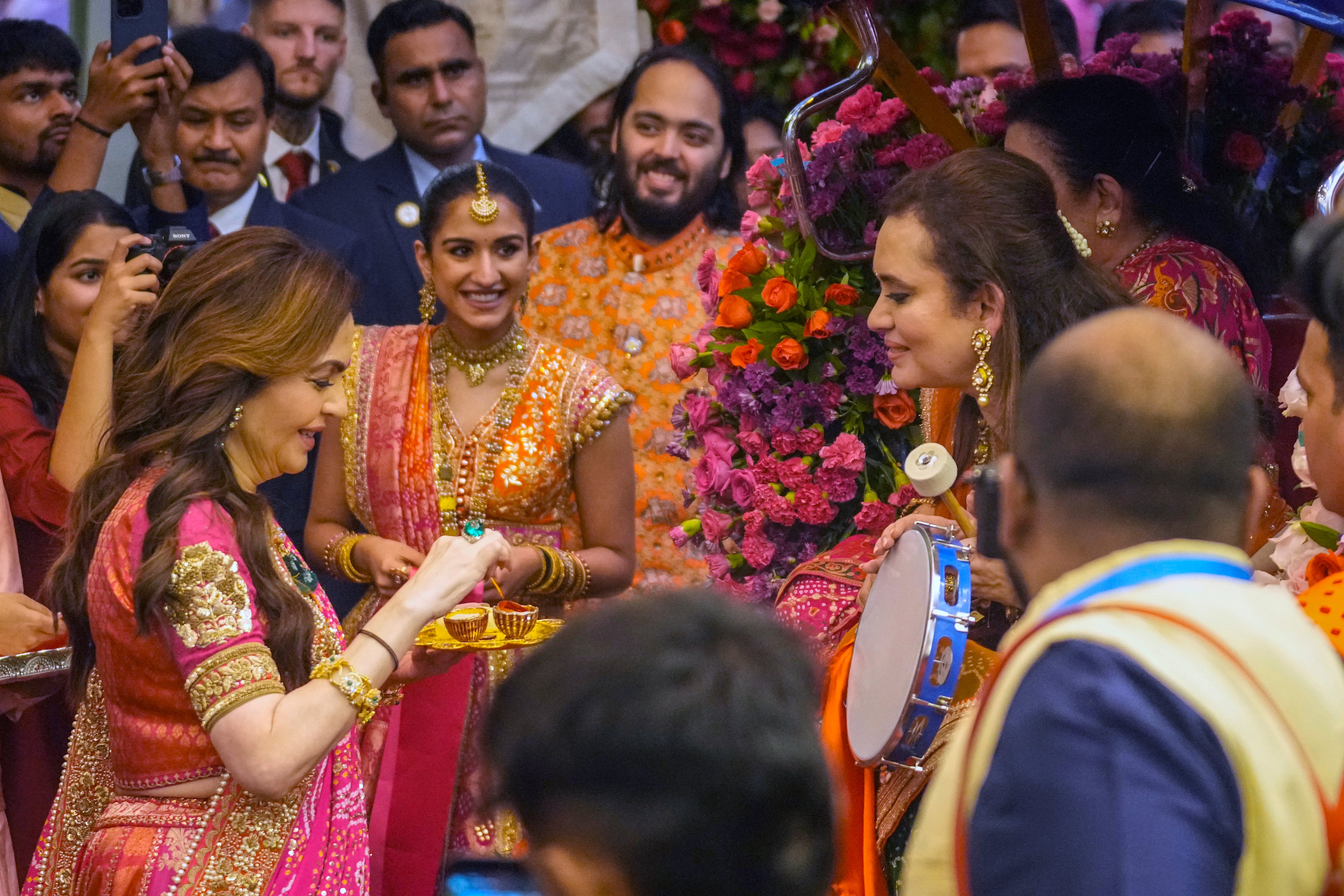 Nita Ambani with Anant Ambani and Radhika Merchant during a pre-wedding ceremony at their residence Antilia in Mumbai, India