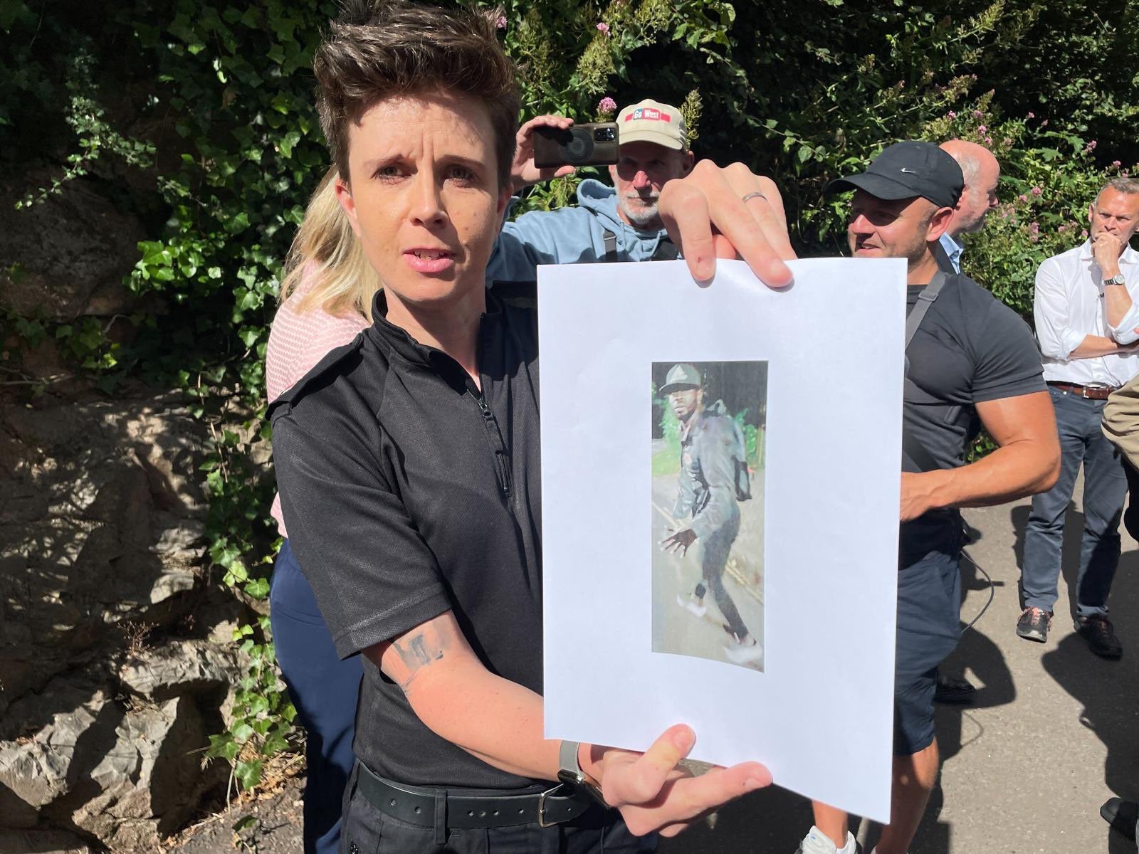 Acting Bristol commander Vicks Hayward-Melen holds image of the suspect in the manhunt