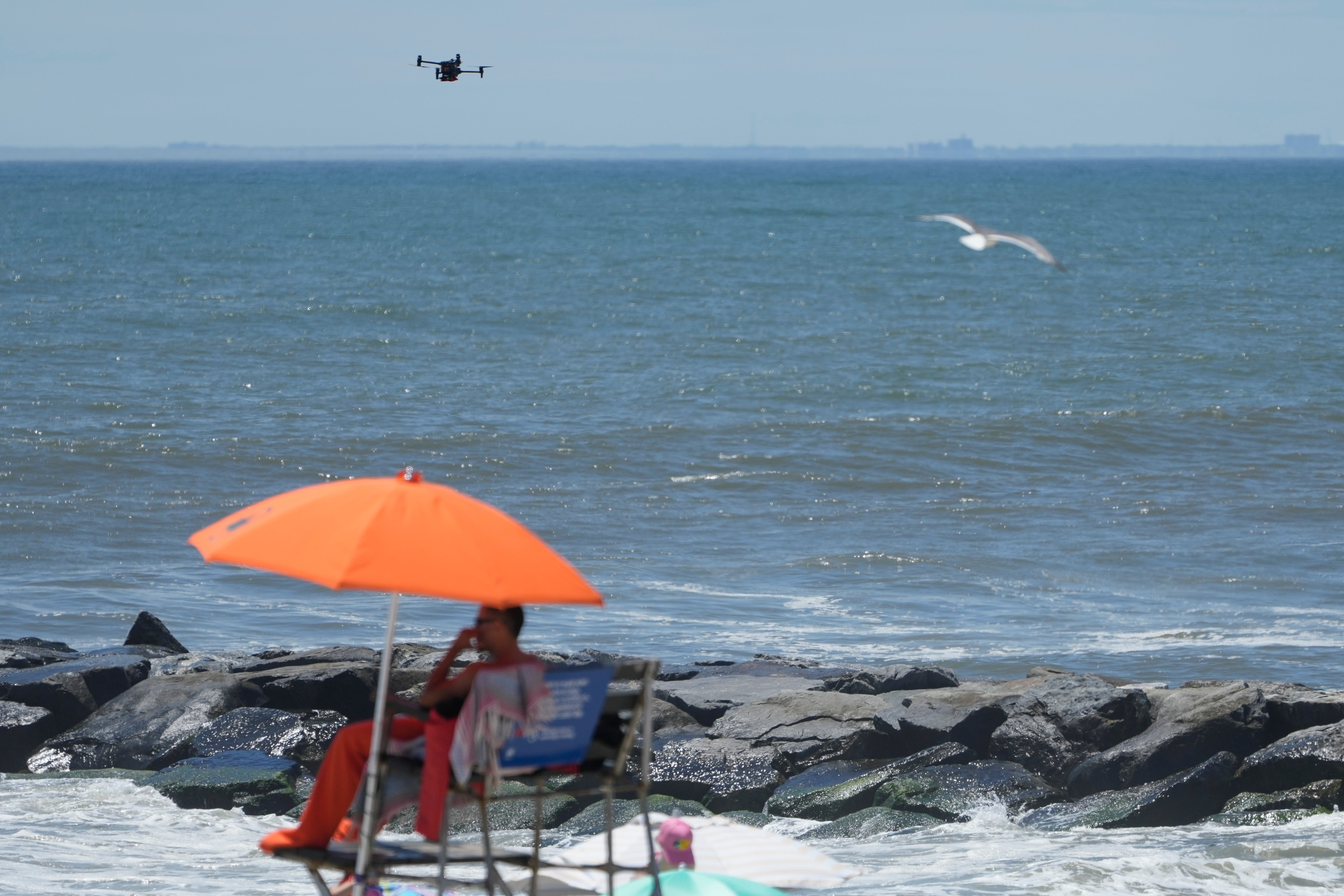 A drone scans the shoreline for signs of struggling swimmers, sharks and other hazards at Rockaway Beach in New York