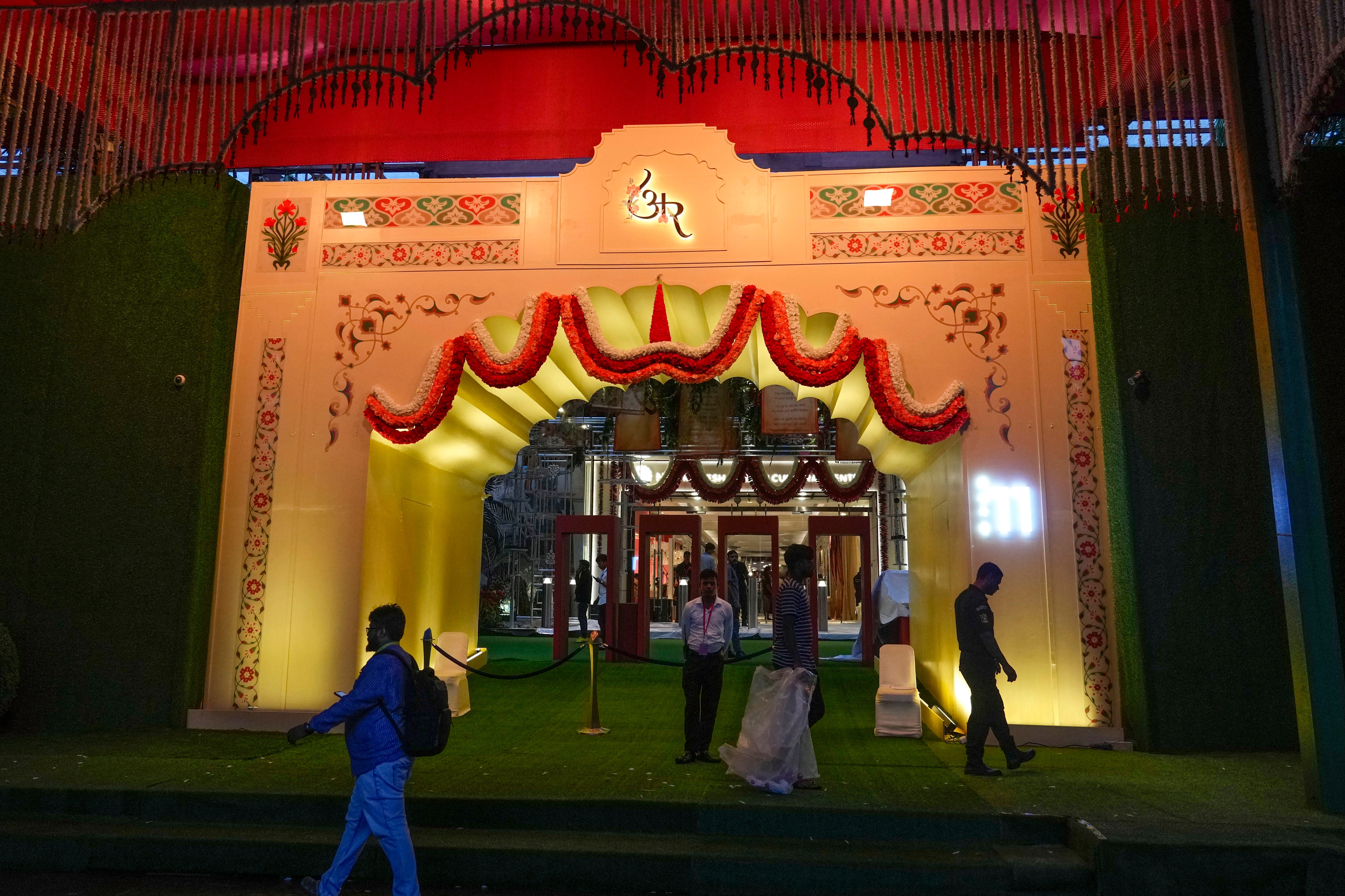 People walk past the venue which has been decorated with lights ahead of the wedding