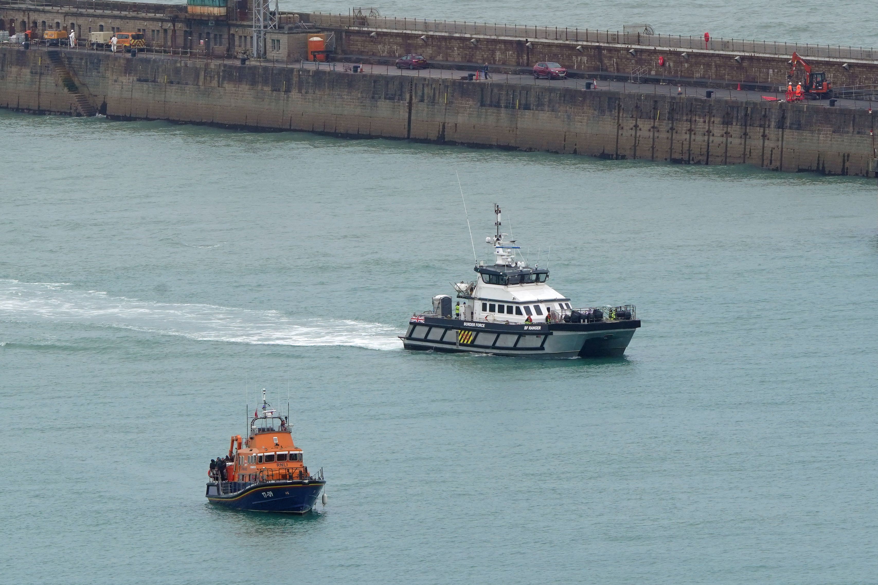 General view of boats. An RNLI Lifeboat and a Border Force vessel with groups of people thought to be migrants onboard, wait to unload in Dover, Kent, following a small boat incidents in the Channel. Picture date: Tuesday July 9, 2024.