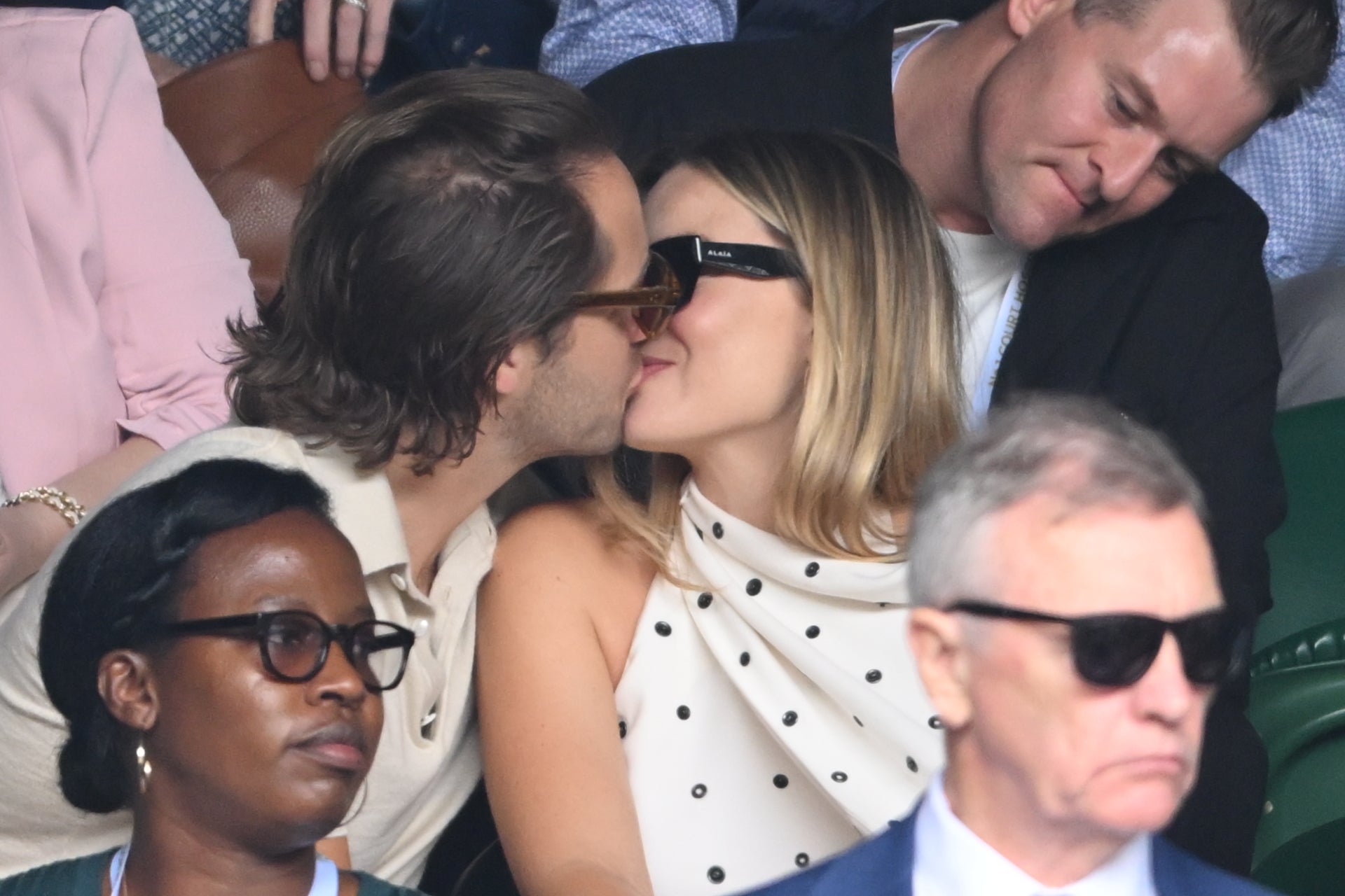 Tom Ackerley and Margot Robbie kiss court-side of Centre Court on day twelve of the Wimbledon Tennis Championships