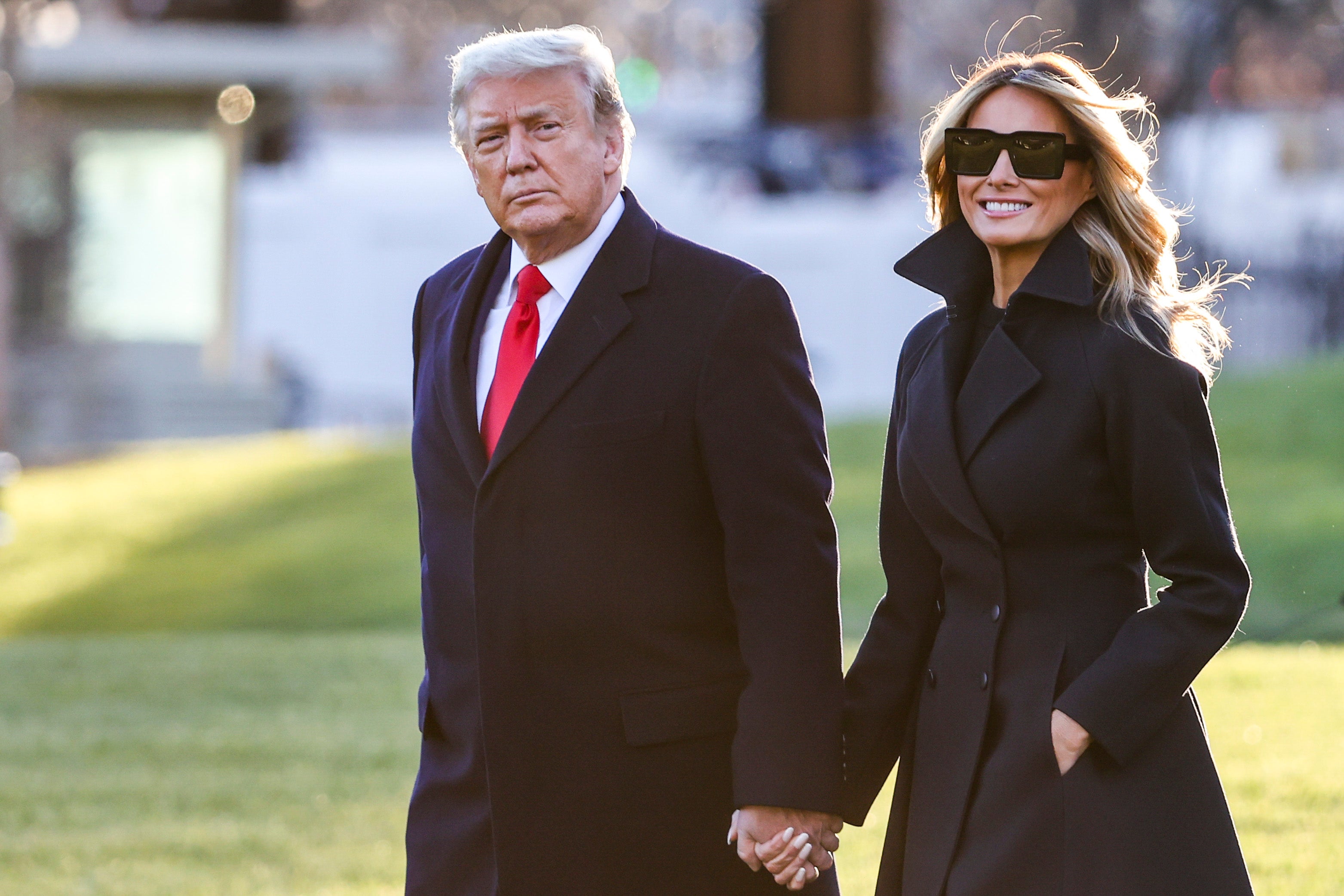 President Donald Trump and first lady Melania Trump walk on the south lawn of the White House on December 23, 2020 in Washington, DC