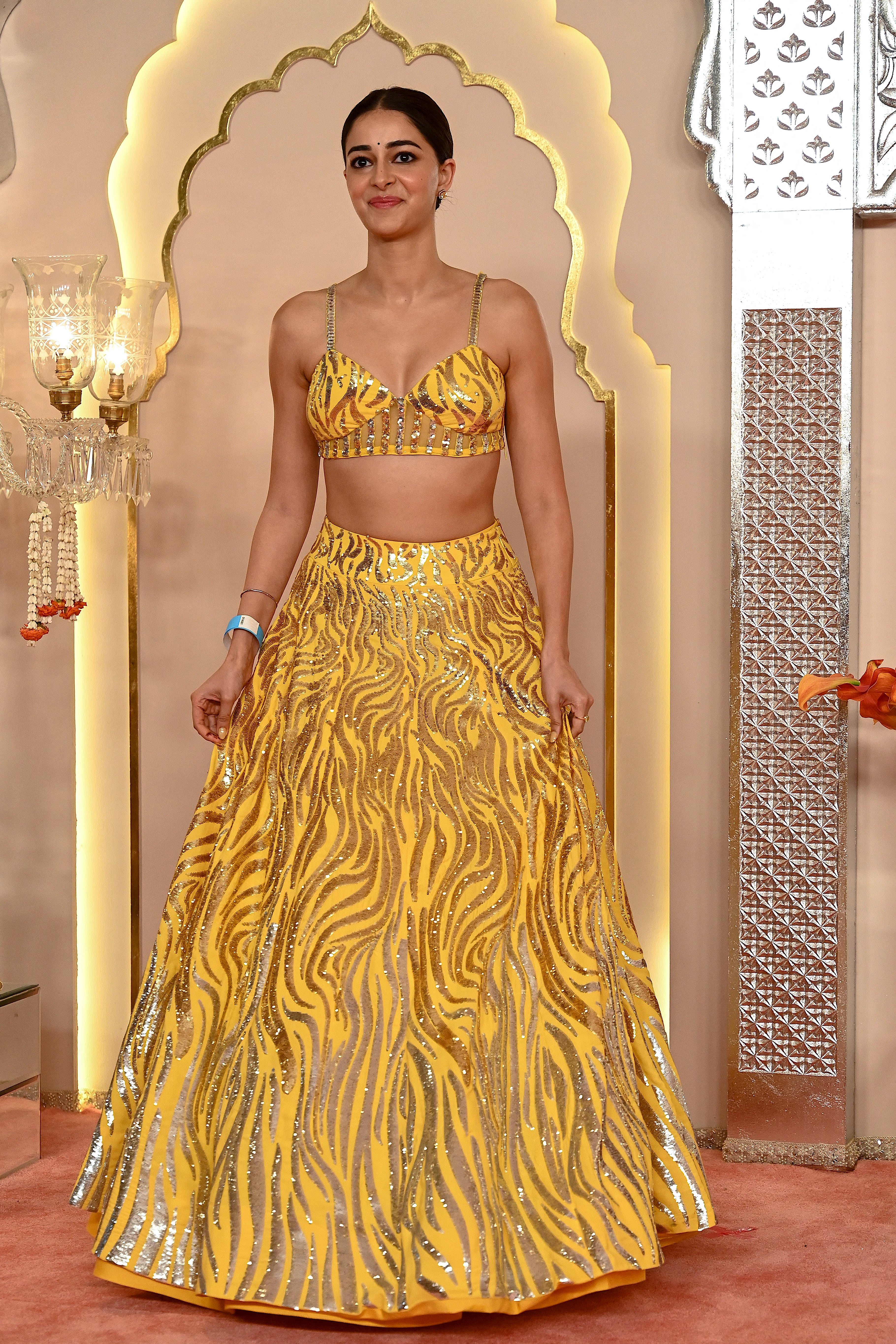 Panday dressed in a vibrant yellow lehenga for the Ambani wedding