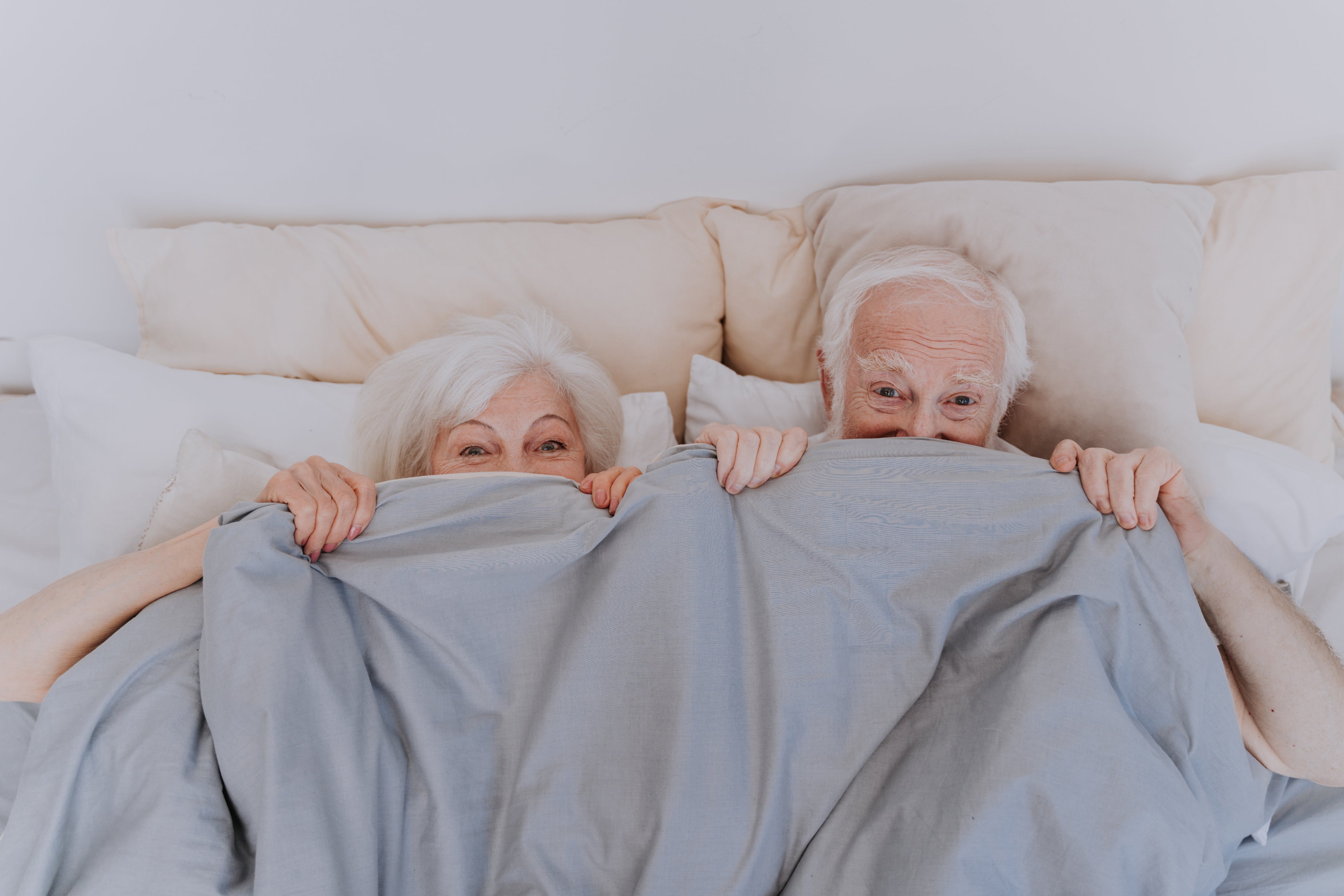 An older couple enjoying some fun in bed