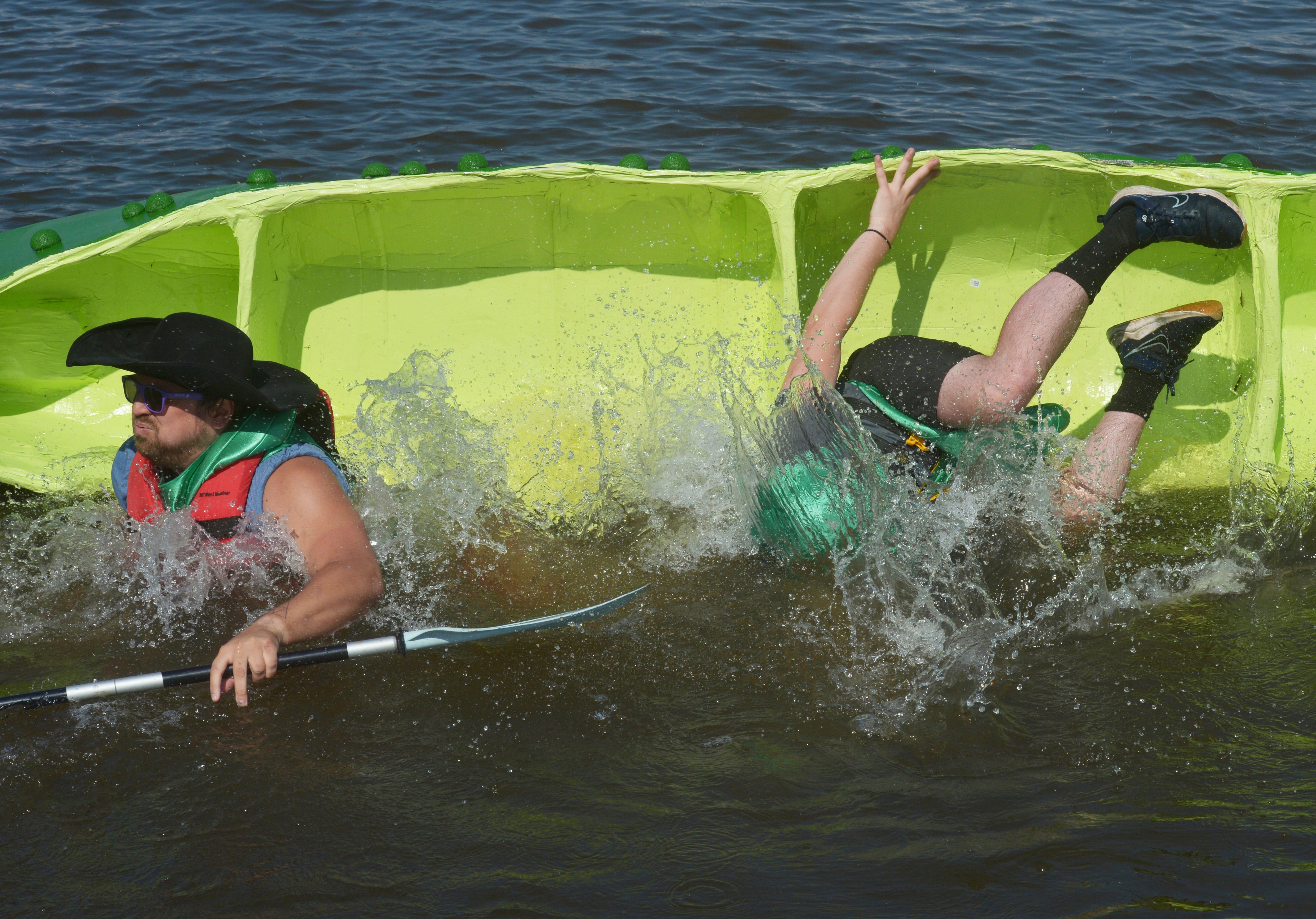 Kyle Brown and Alex Meilstrup, with Honor Credit Union, dump during the start of the first heat, Thursday, July 11, 2024, during the United Way of Southwest Michigan Rock The Boat Cardboard boat races held at The Inn at Harbor Shores in St. Joseph, Michigan