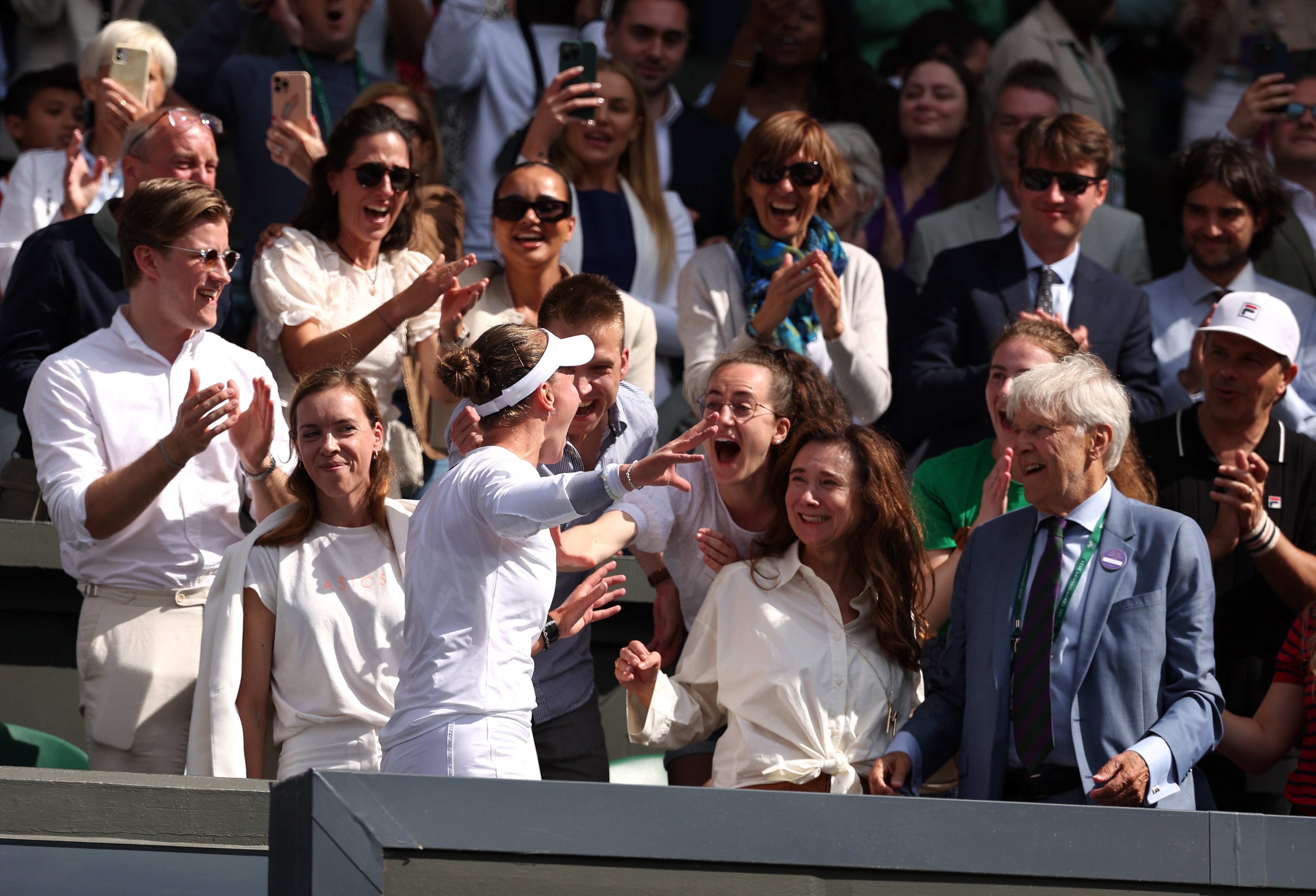 Krejcikova celebrates with her team after claiming her second singles grand slam