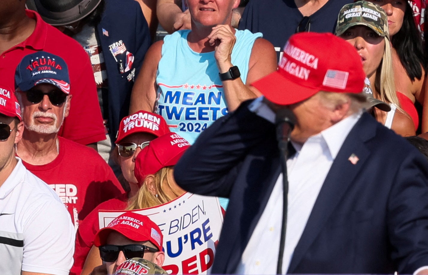 Trump turned in the direction of the sounds, grabbed his ear and blood was seen on his face as he ducked for cover and screams came from the crowd. More shots were heard after Trump dropped behind the lectern