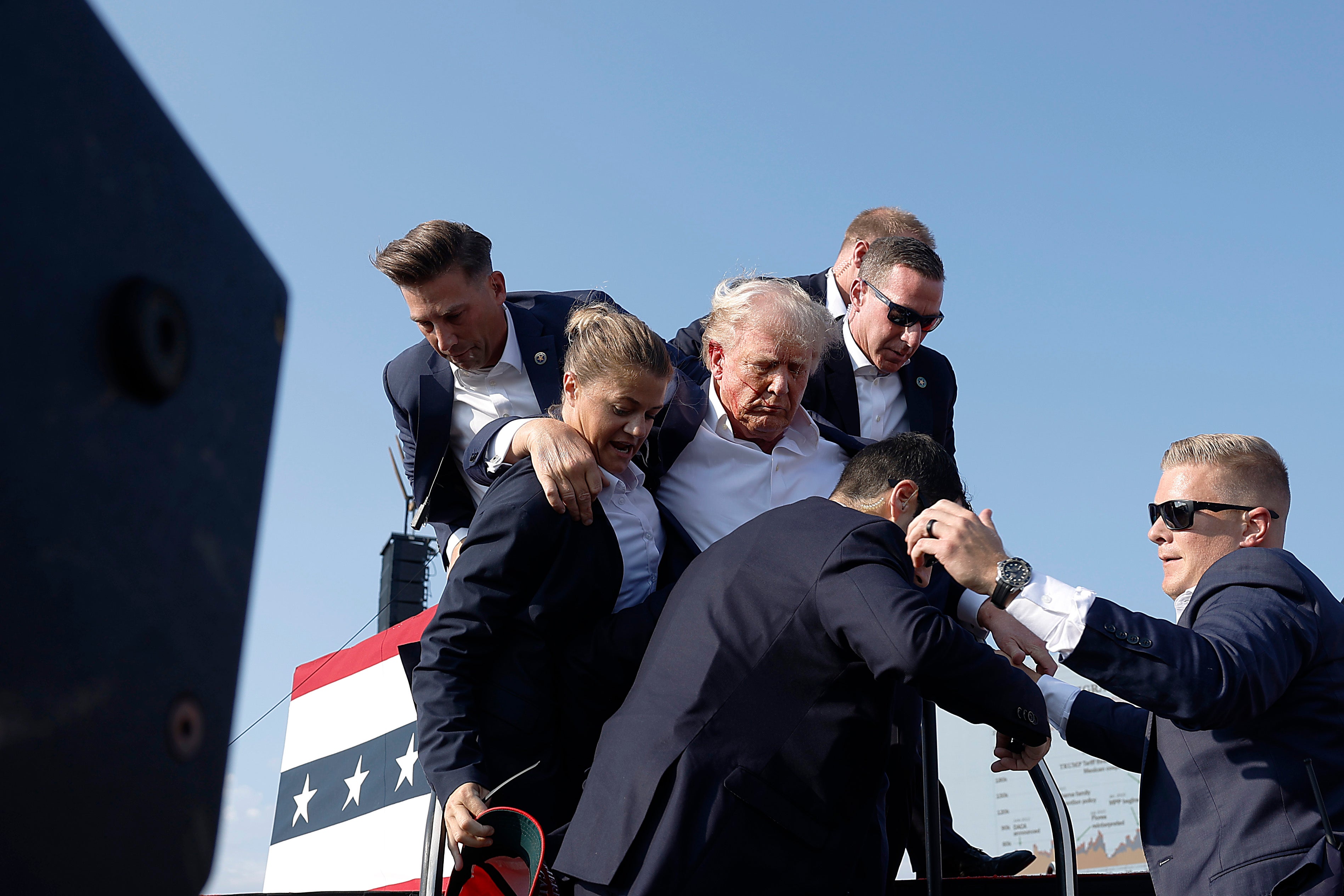 Former President Donald Trump pumps his fist as he is rushed offstage during a rally on July 13, 2024 in Butler, Pennsylvania