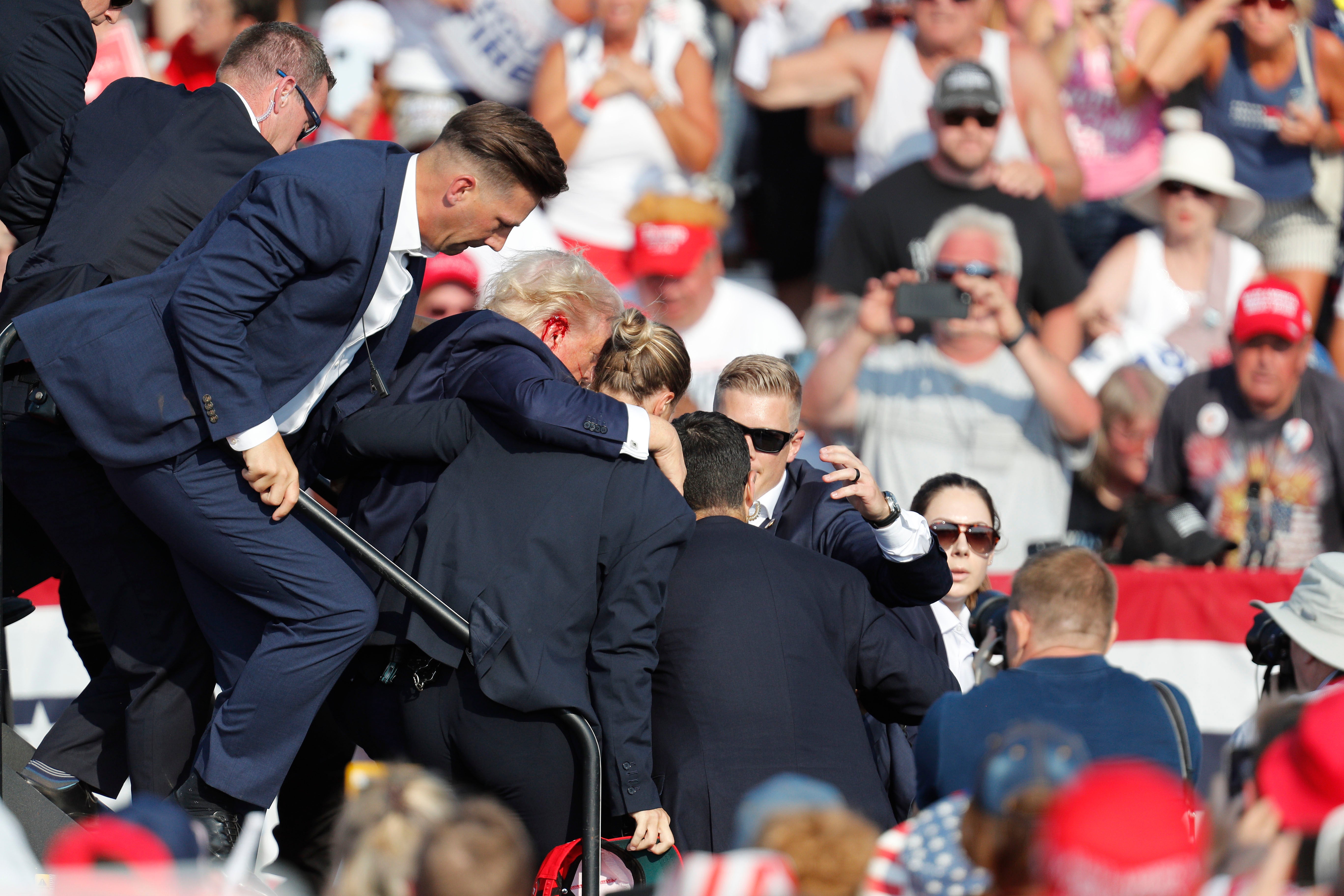 Trump is rushed off stage by Secret Service detail after the shooting. However, they have been questioned about how the shooting happened and their response