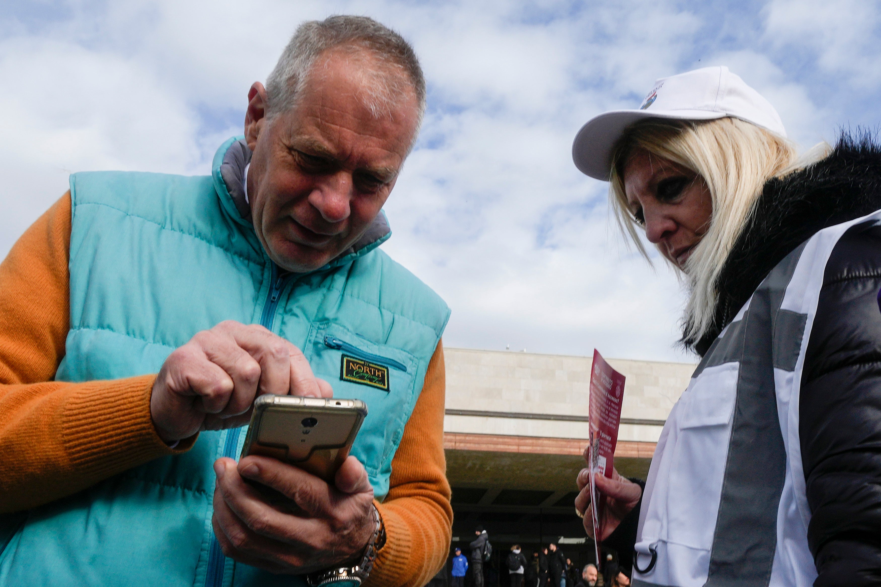 A tourists is checked by a steward for QR code fee access outside the main train station in Venice, Italy