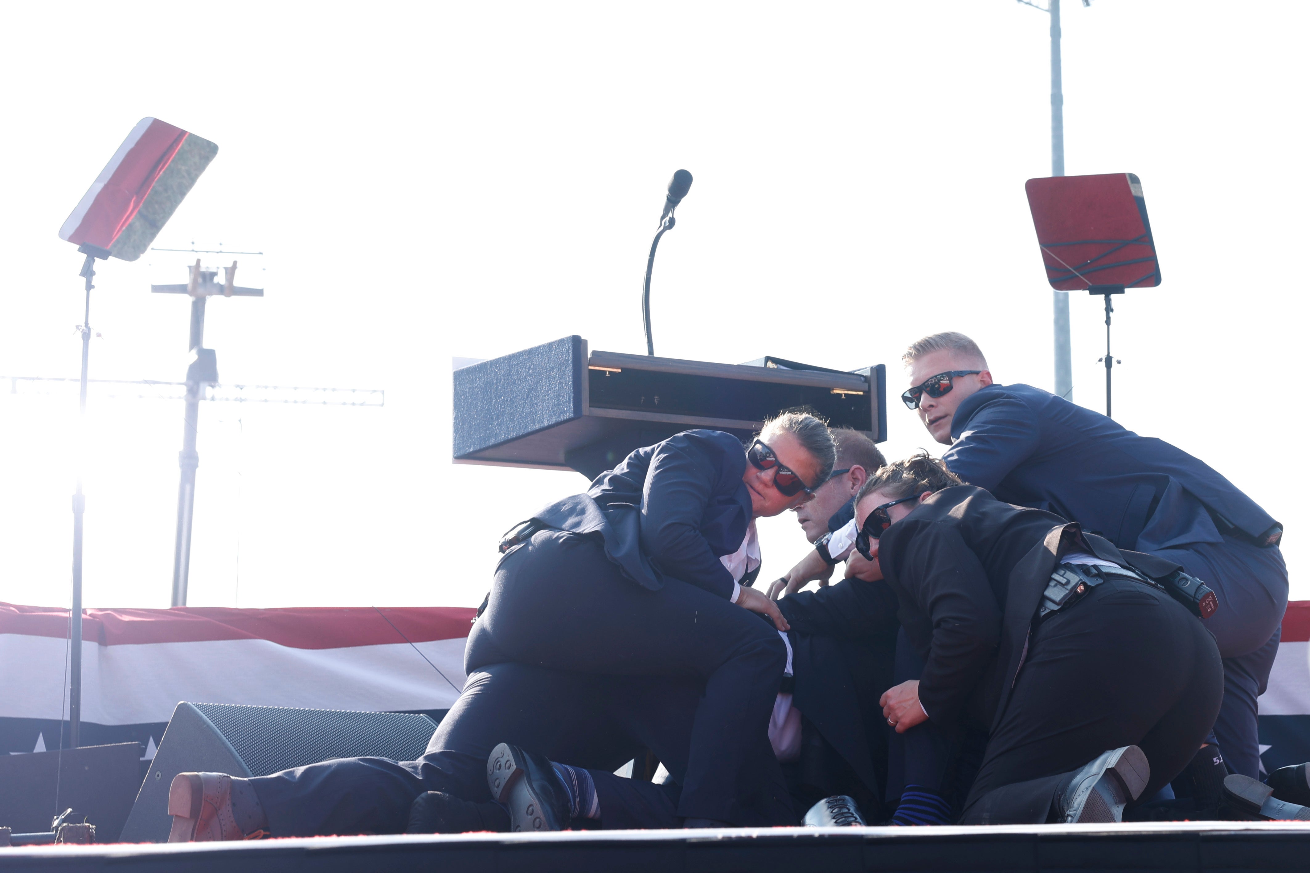 Trump is covered by his security detail after the assassination attempt in Butler, Pennsylvania