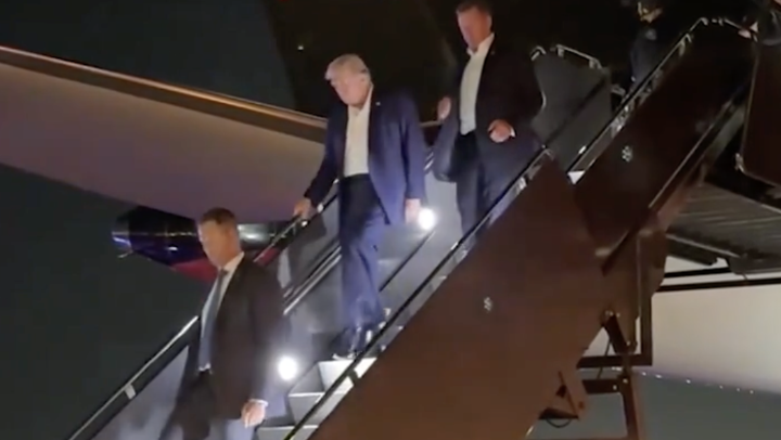 Donald Trump walks down the steps of his plane in New Jersey on July 13, 2024 after the assassination attempt at a rally in Pennsylvania