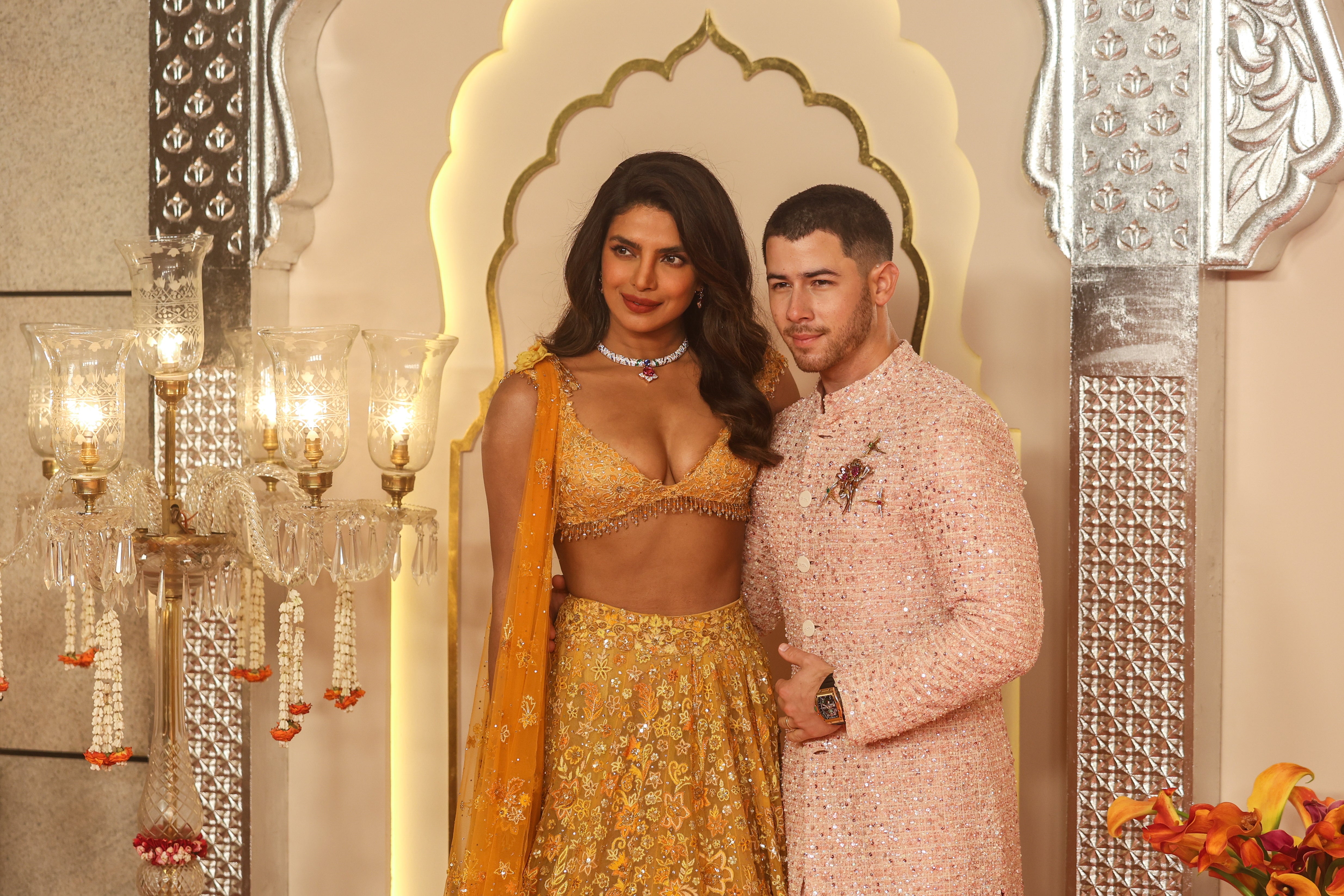 Priyanka Chopra (L) and her husband US singer Nick Jonas pose for photographs