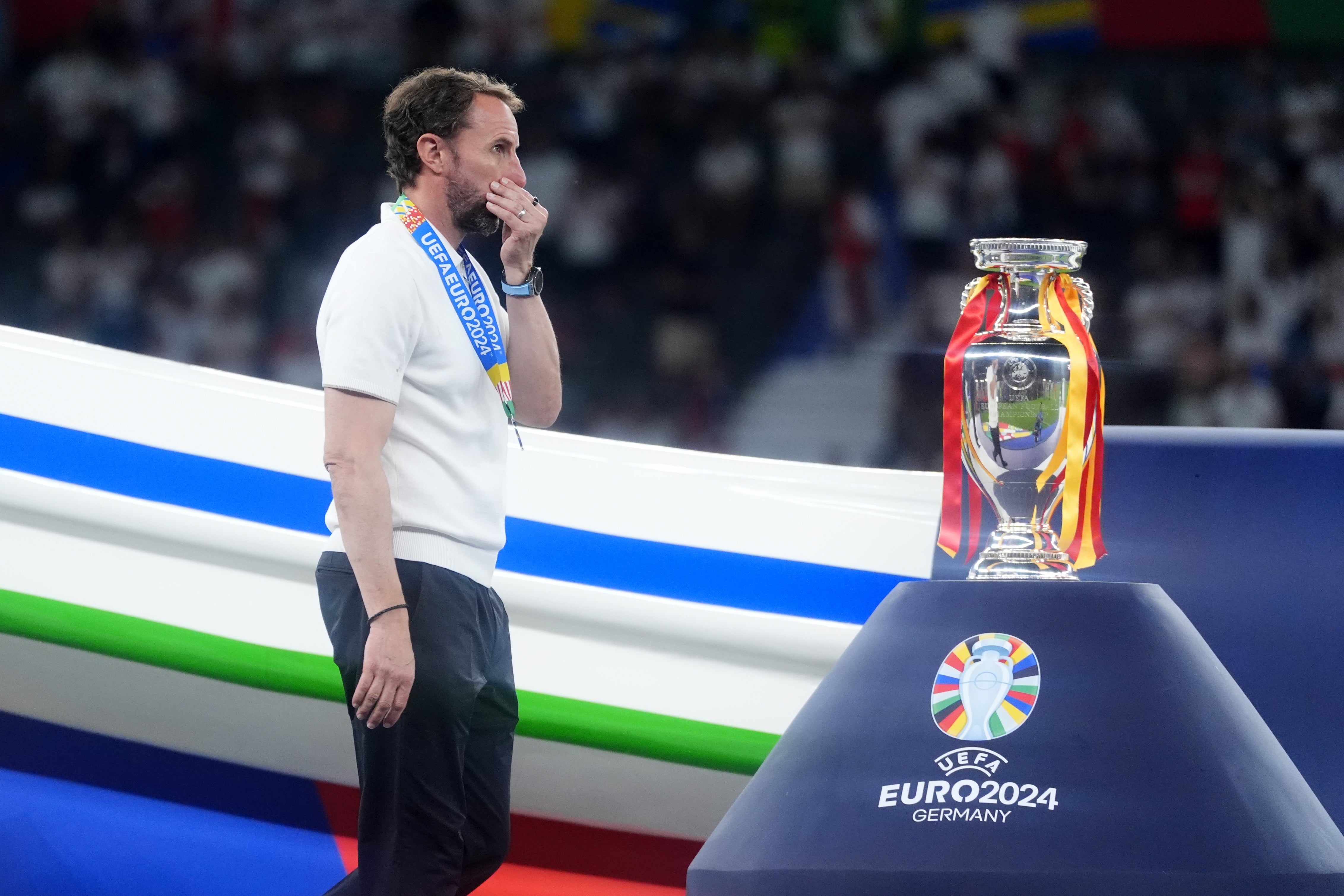 Gareth Southgate walks past the trophy