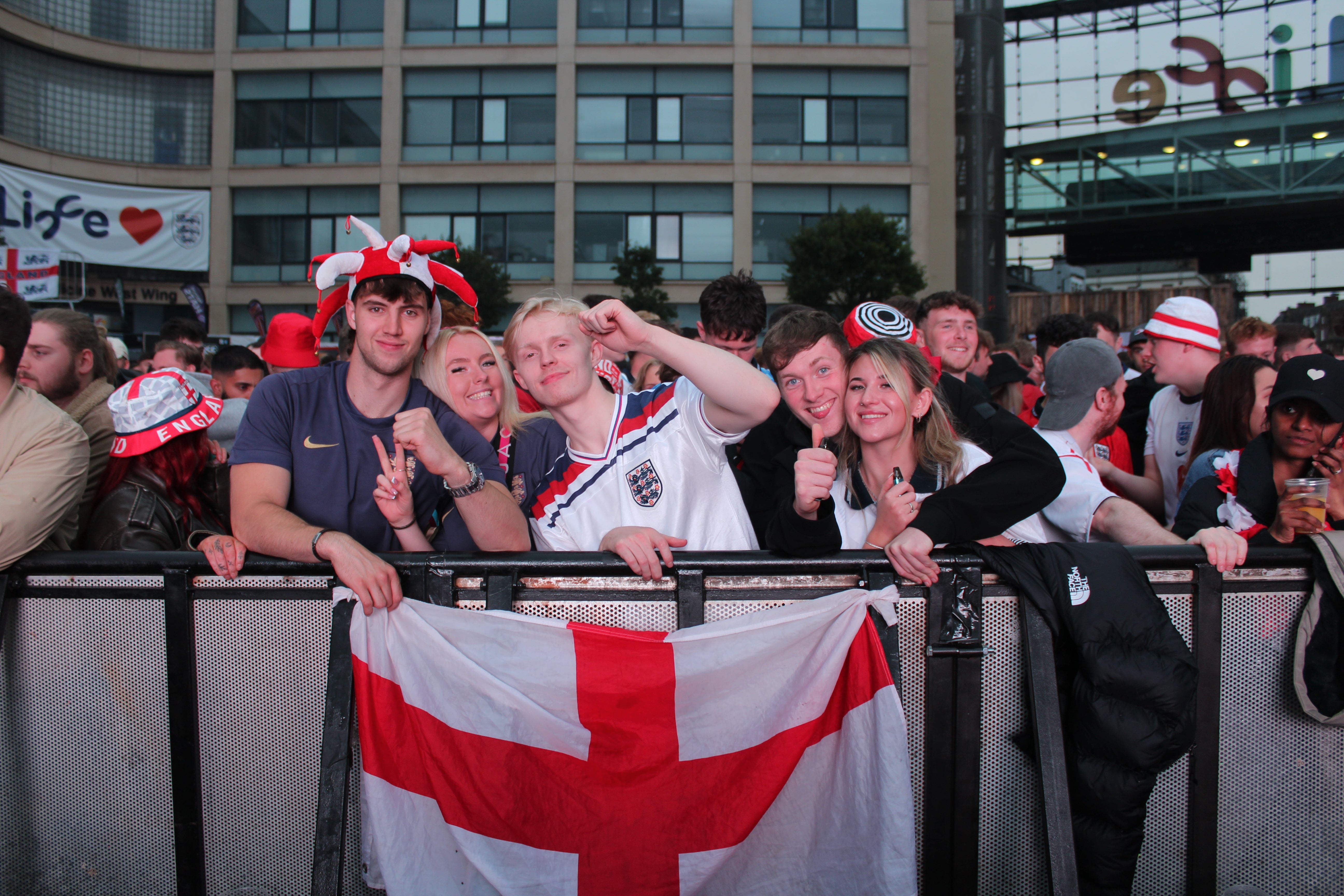 Kennedy Campbell (2L), 24, poses with her friends at the front of the standing crowd at Newcastle fan zone