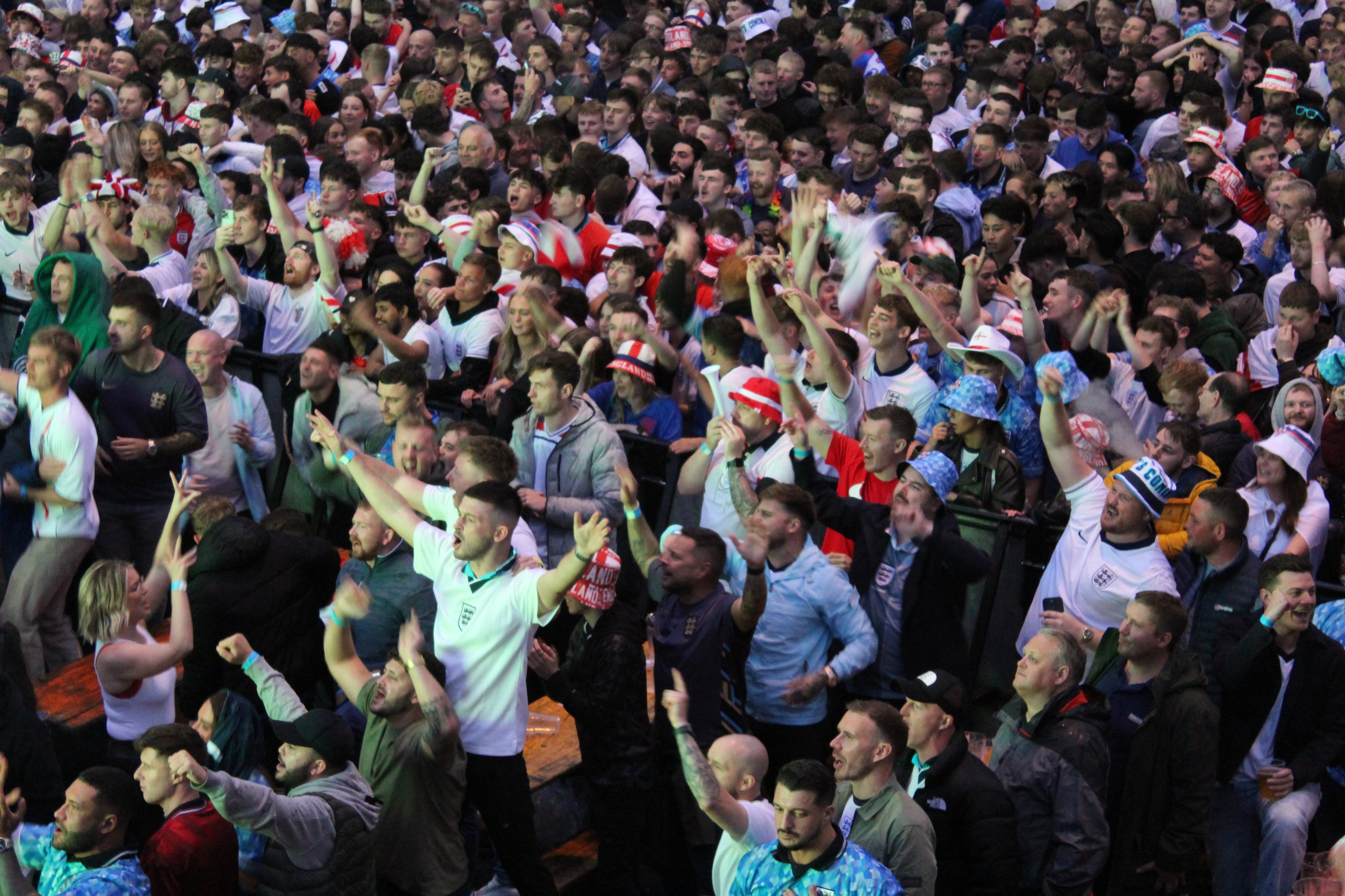 England fans throw beers in the air and break out into a rendition of “Football’s coming home” after Cole Palmer scores