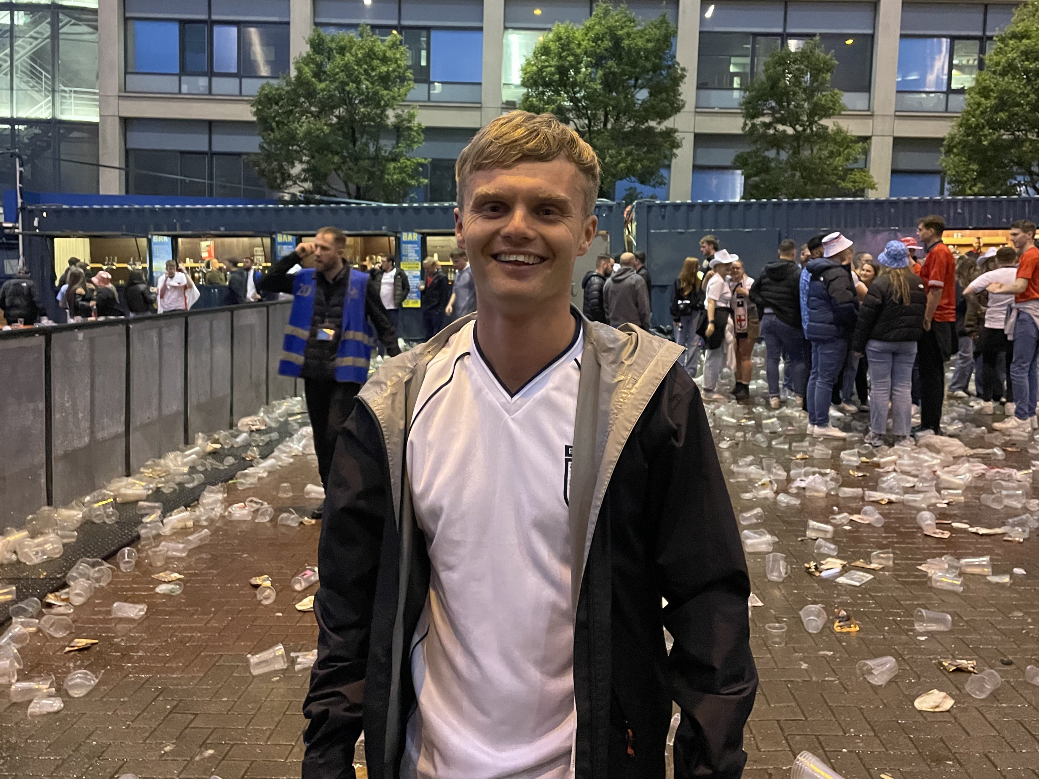 24-year-old Steven Currie tries to stay positive after a “gutting” loss to Spain. Hundreds of empty pint cups litter the floor around him