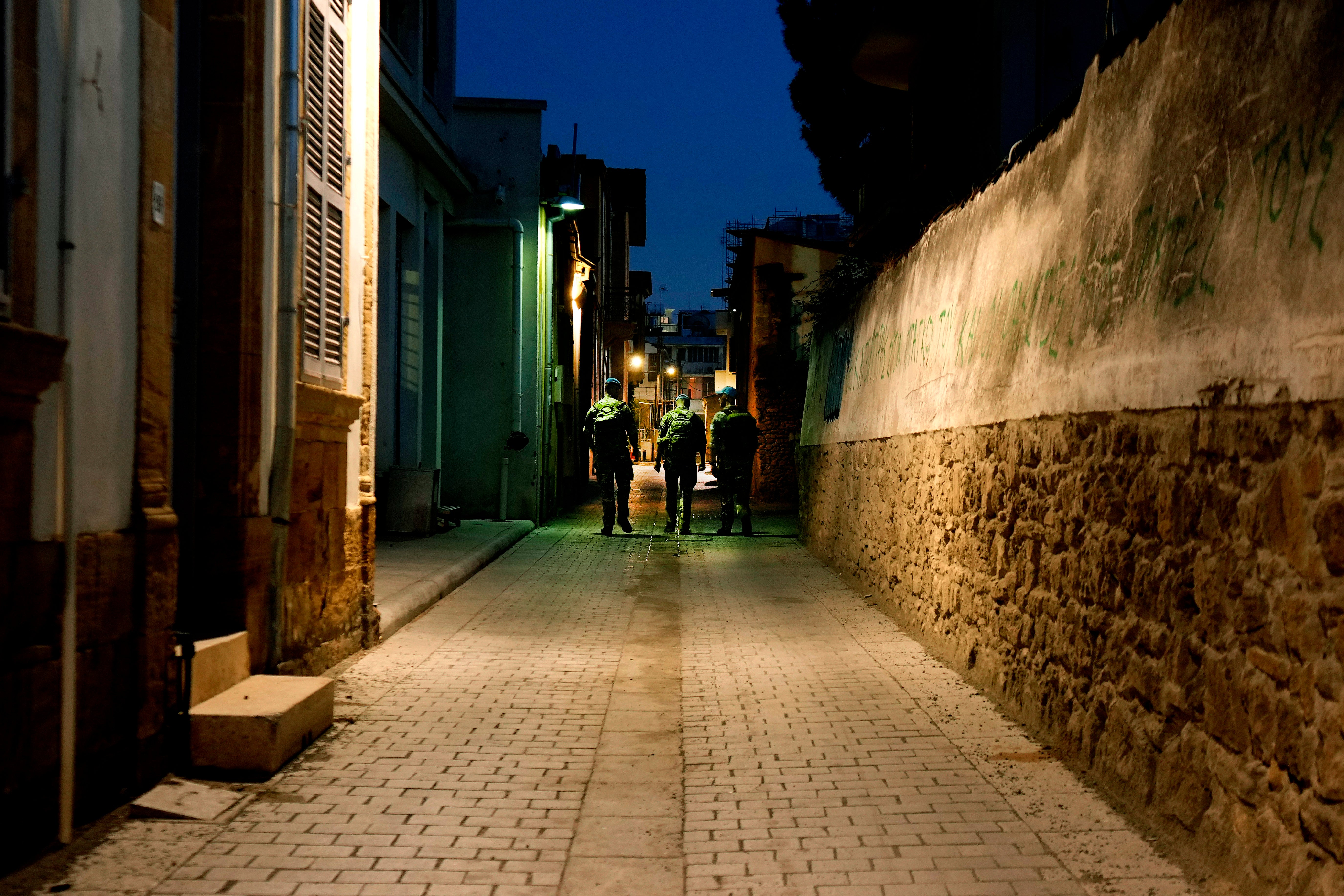 U.N. Peacekeepers walk by the U.N. controlled buffer zone in the central of the divided capital