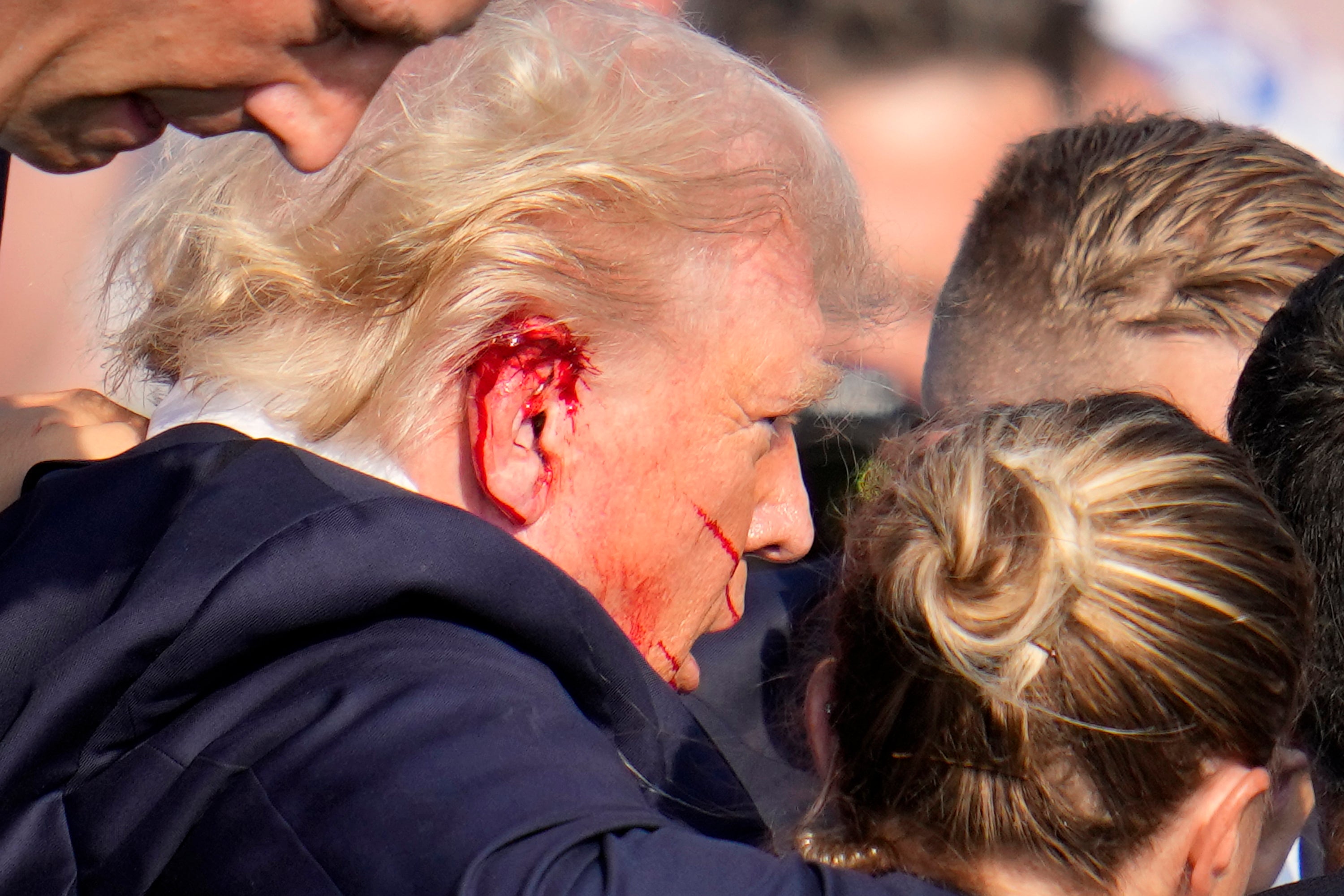 Donald Trump is escorted to a motorcade following the attempted assassination (Gene J. Puskar/AP)