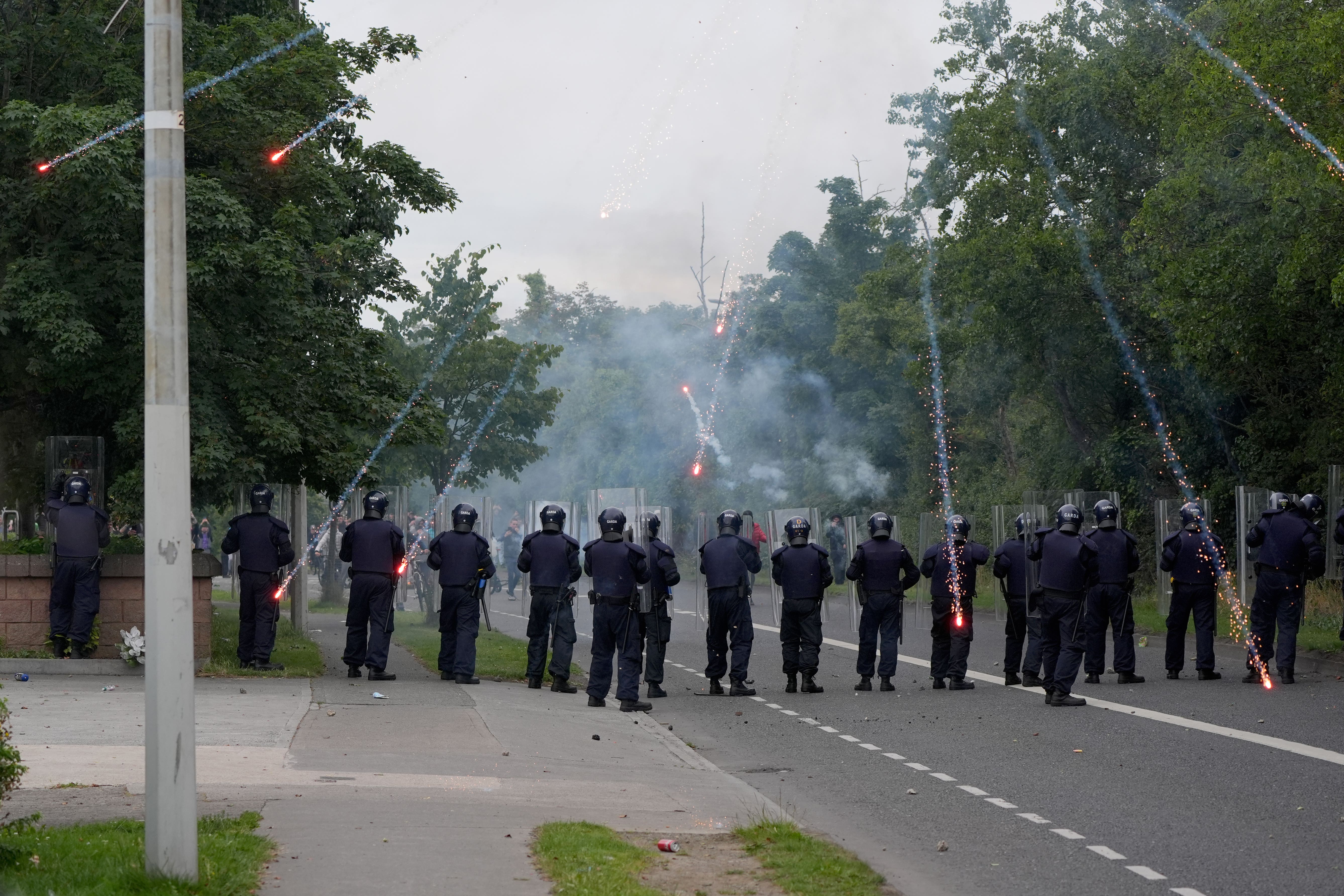 Protesters fire fireworks at gardai (Niall Carson/PA)