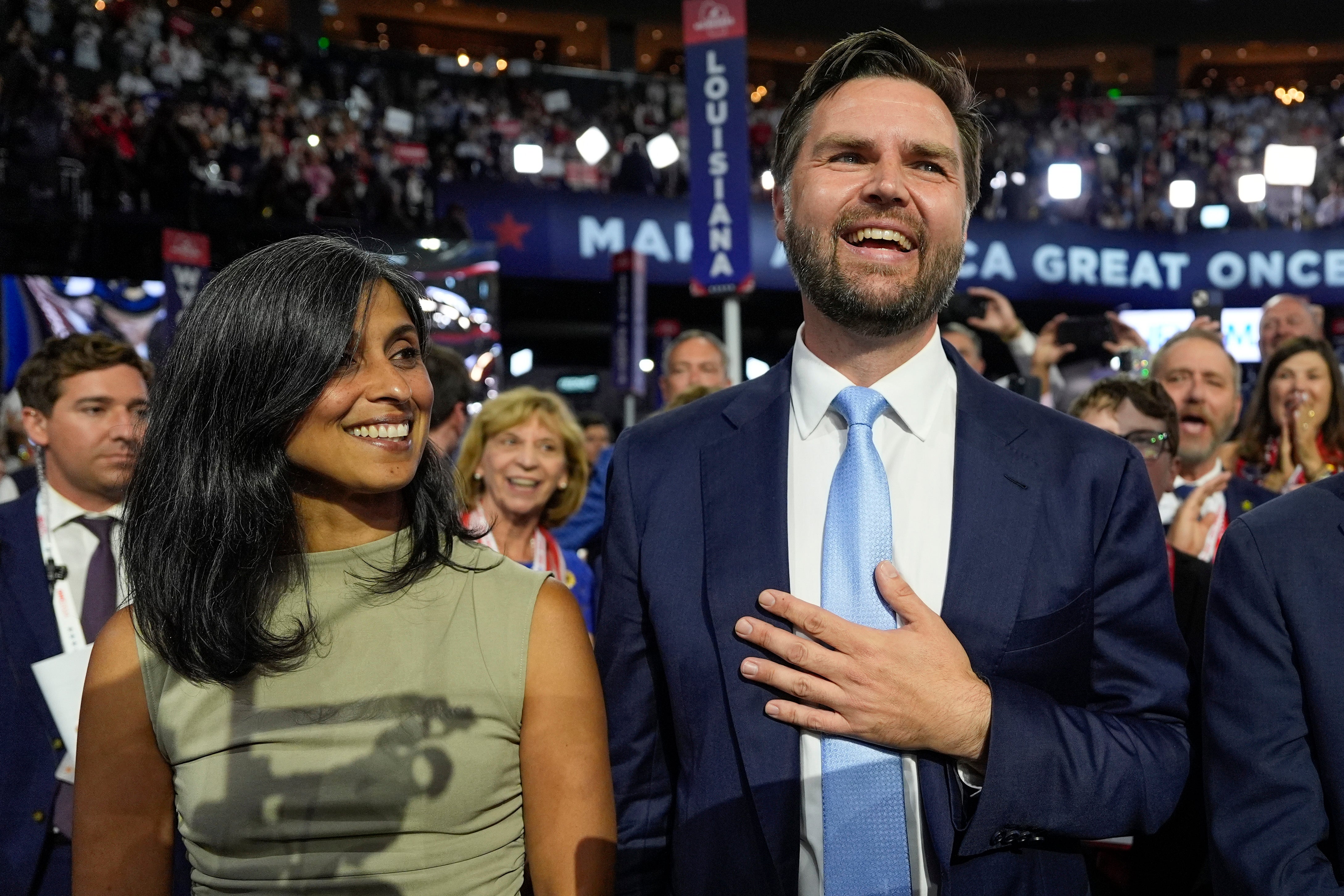 JD Vance and his wife Usha Chilukuri Vance arrive on the floor during the first day of the 2024 Republican National Convention on Monday, July 15, 2024, in Milwaukee.