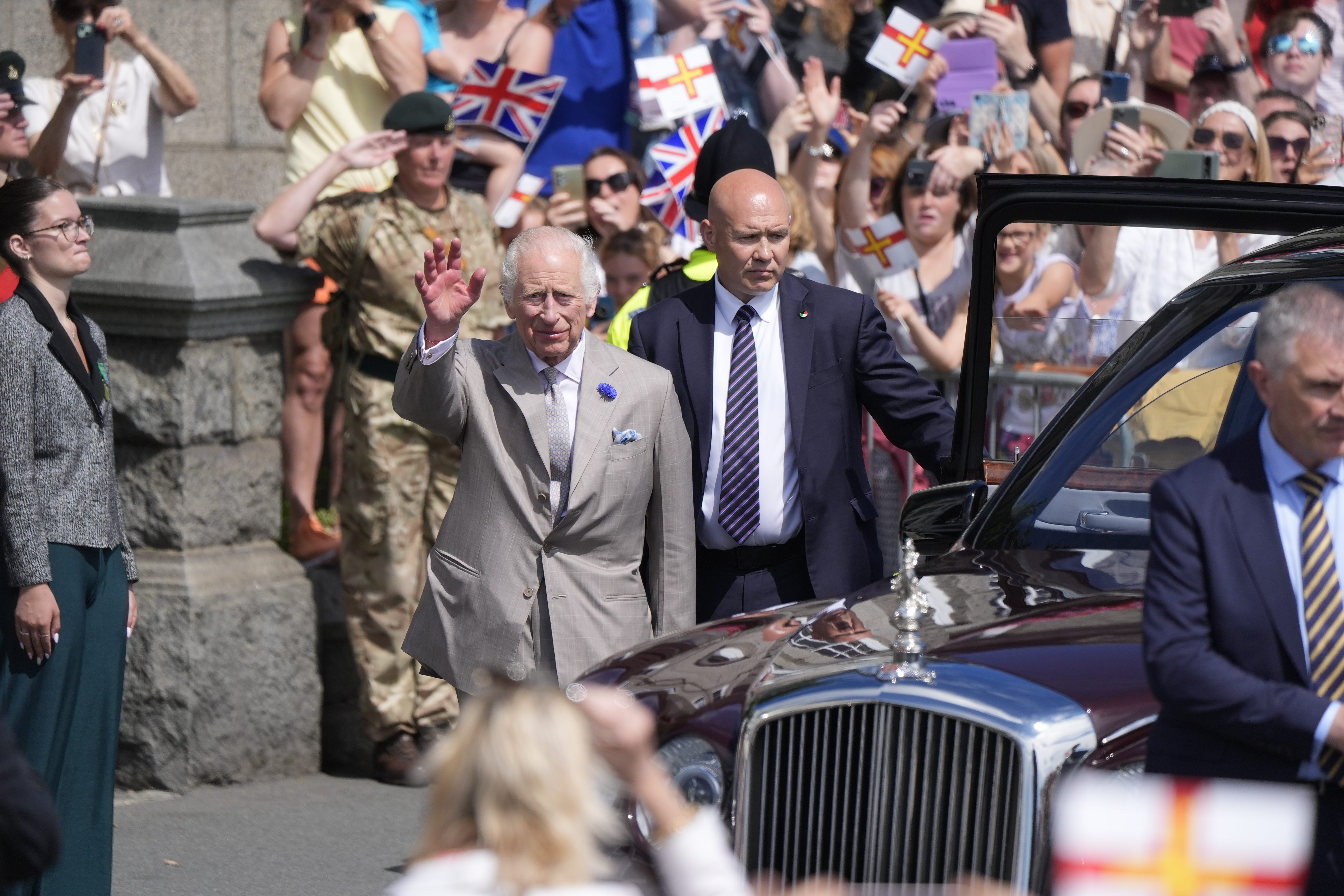 Charles waves to the crowd in Guernsey (Andrew Matthews/PA)