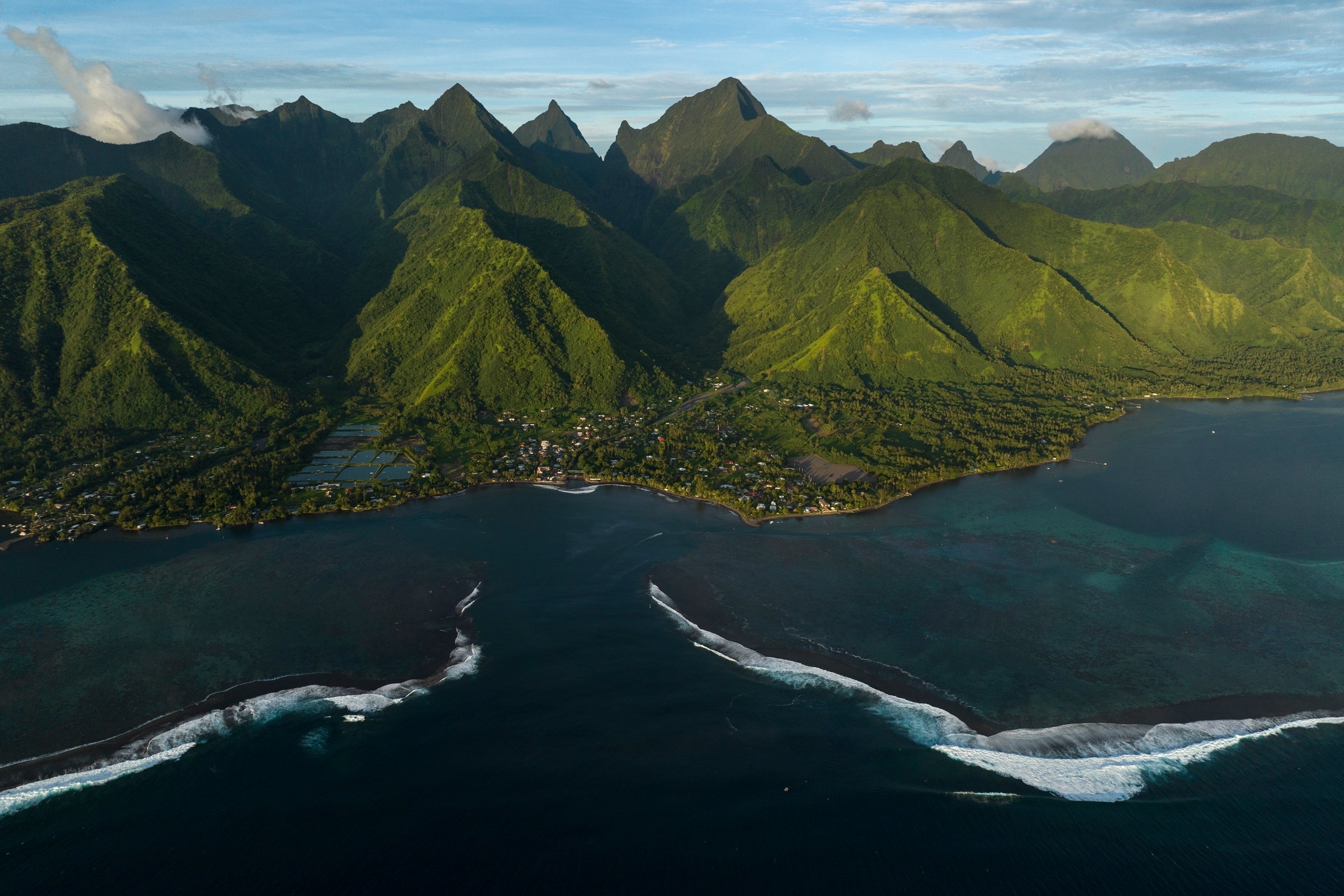 An aerial view of French Polynesia, one of the most isolated island nations in the world. Like other south Pacific islands, French Polynesia is sinking. It used to be thought that this was solely due to sea level rise because of climate change, although recent research has suggested that the islands are also being dragged underneath the water by tectonic plate activity in the region at the same time
